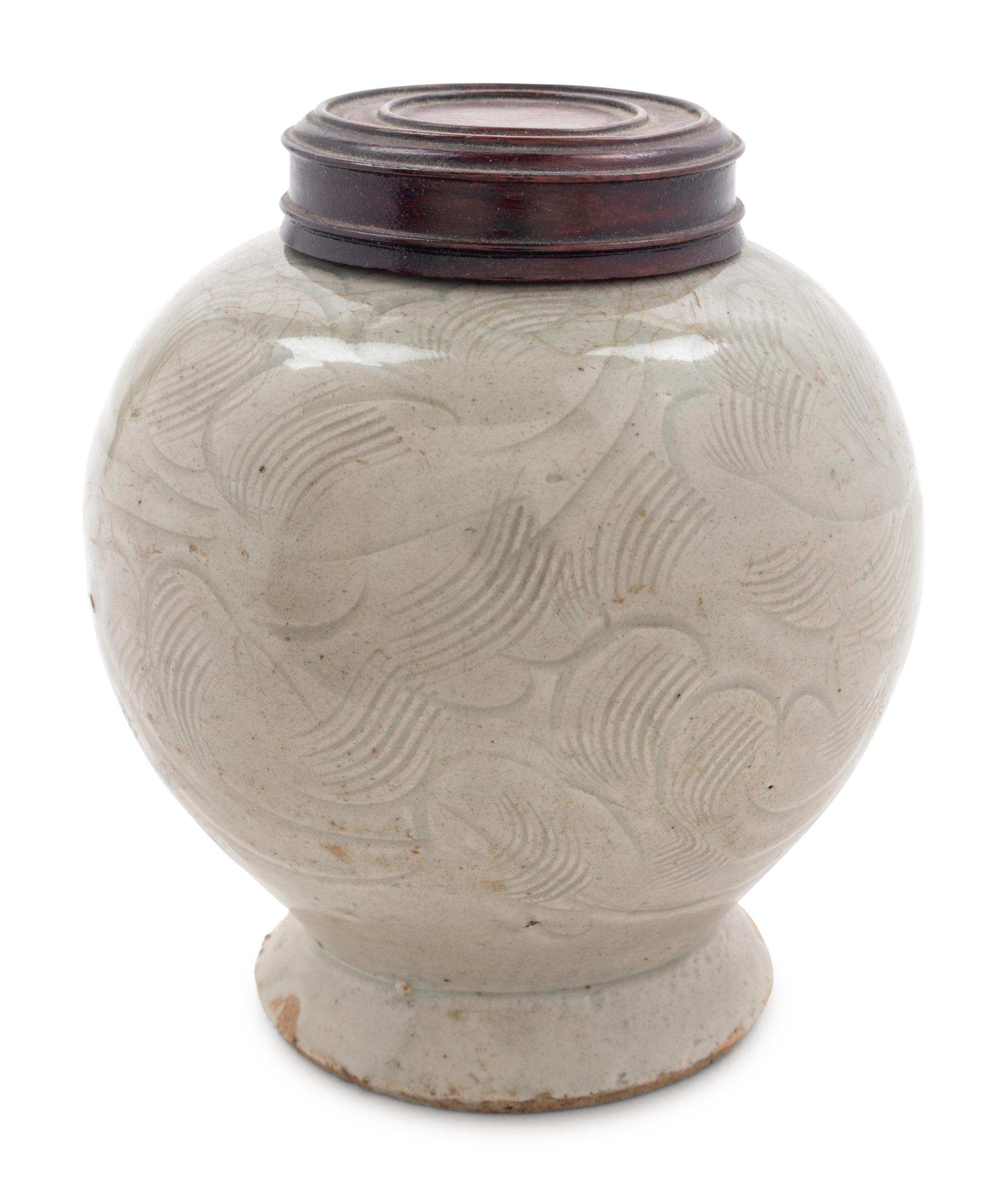 A Celadon Glazed Carved 'Floral' Porcelain Jar
