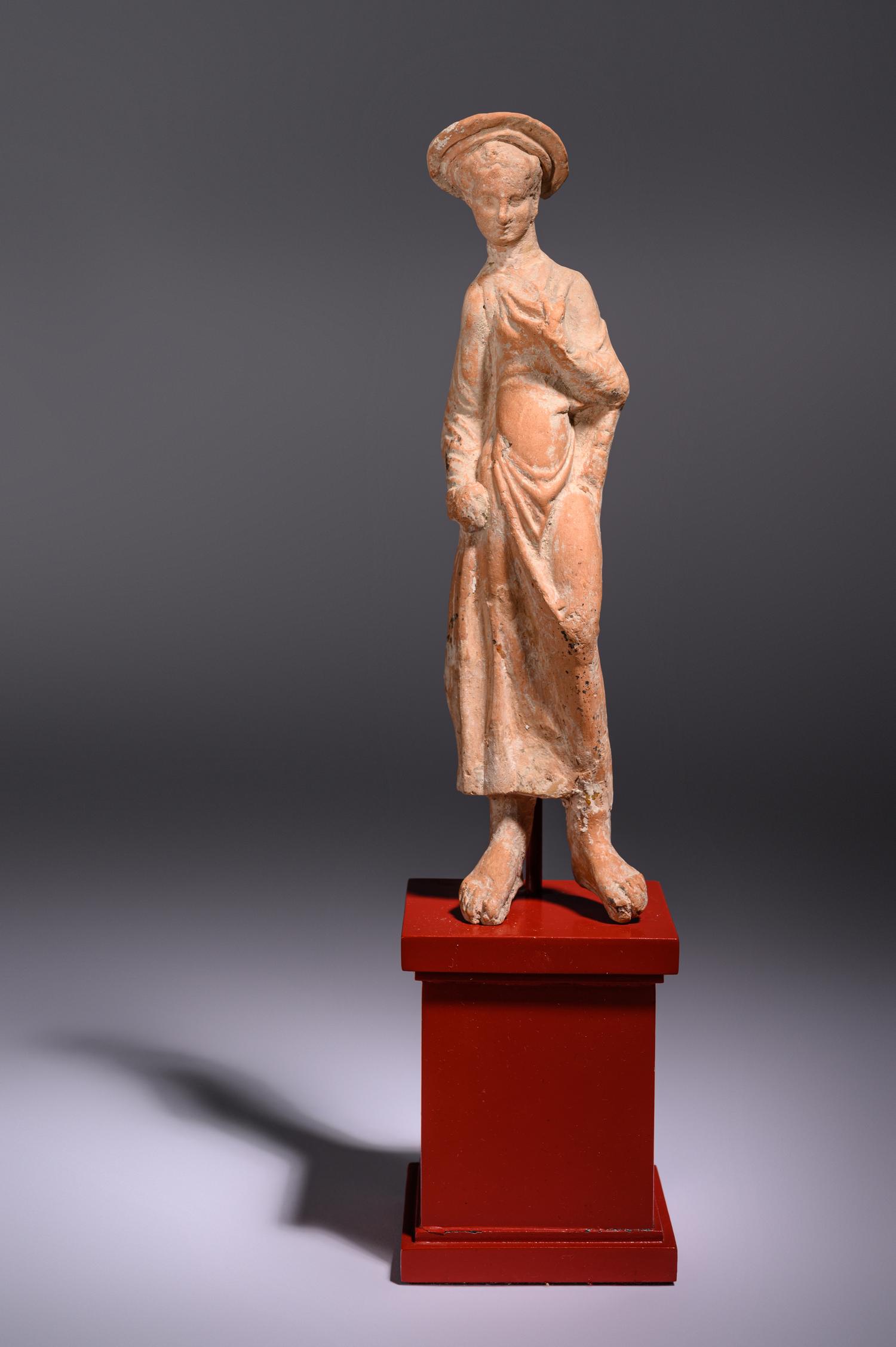A Greek Terracotta Woman Wearing a Polos (broad-rimmed hat)