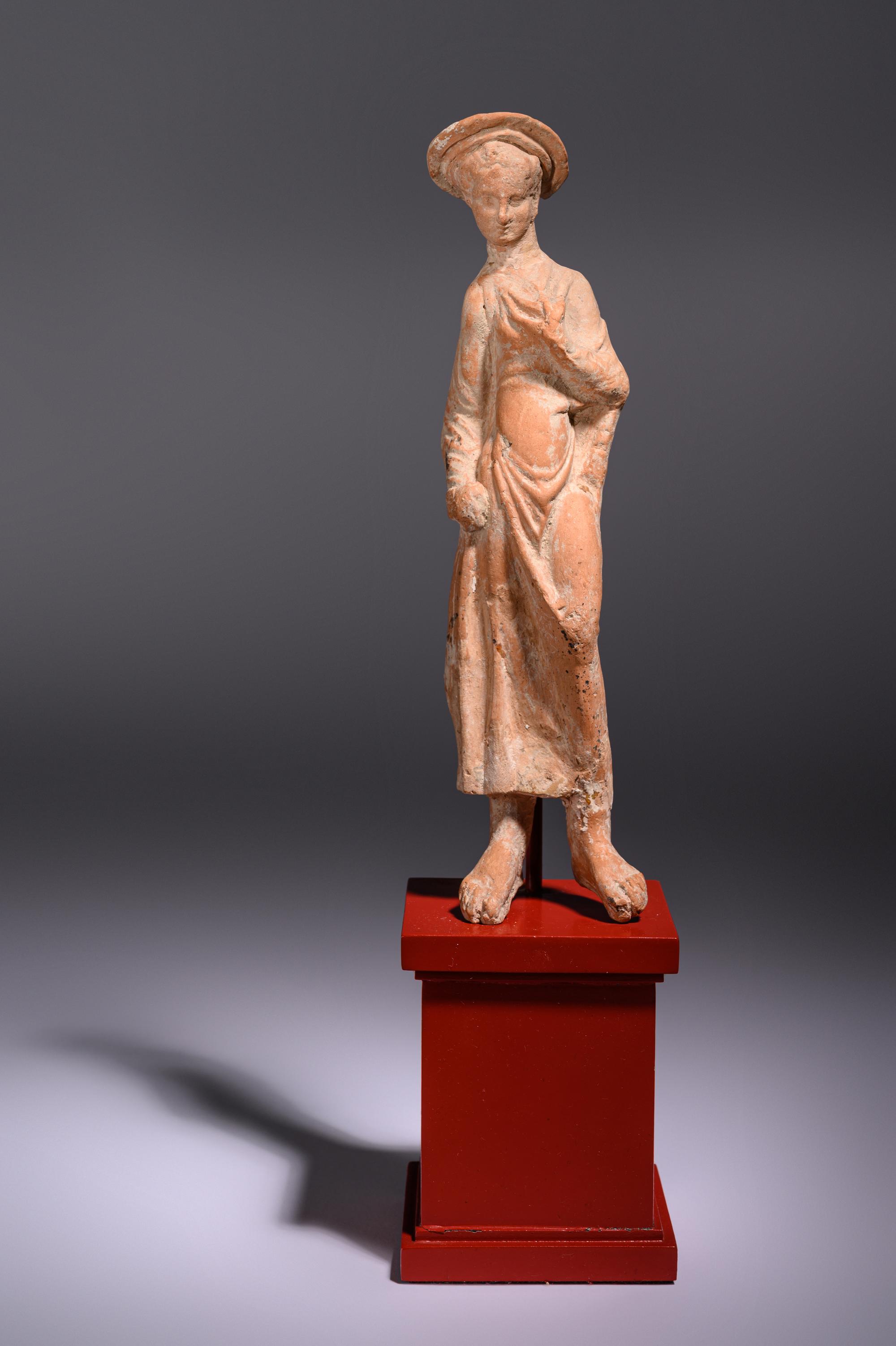 A Greek Terracotta Woman Wearing a Polos (broad-rimmed hat)