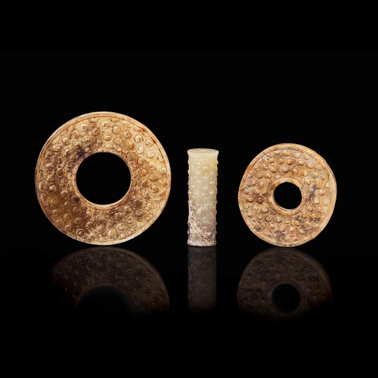 An assembled set of two small Chinese jade bi discs and a jade tube, Warring State period 戰國 玉系璧兩件及玉勒子一