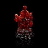 A Chinese carved amber figure of a sage and acolytes