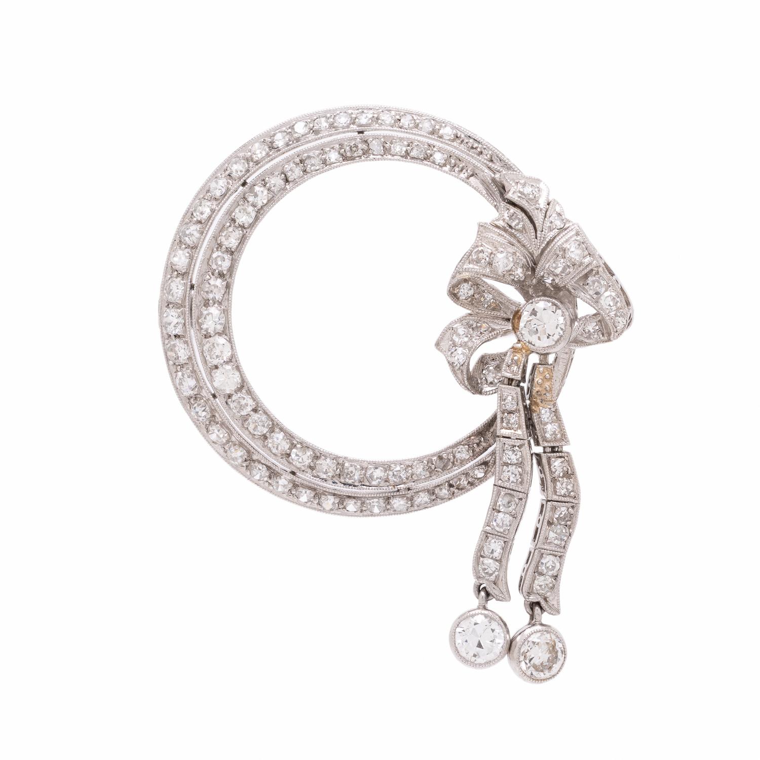 Diamond and Platinum Circle Brooch with Articulated Bow