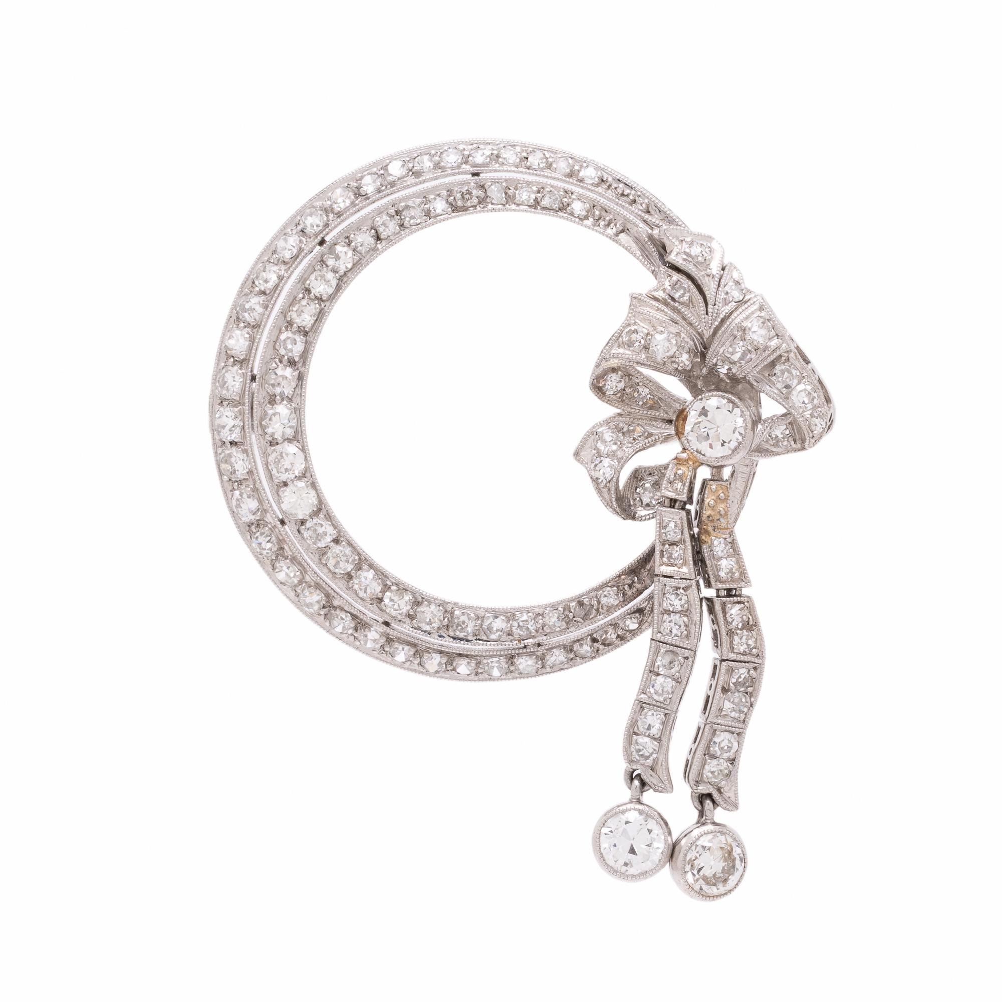 Diamond and Platinum Circle Brooch with Articulated Bow