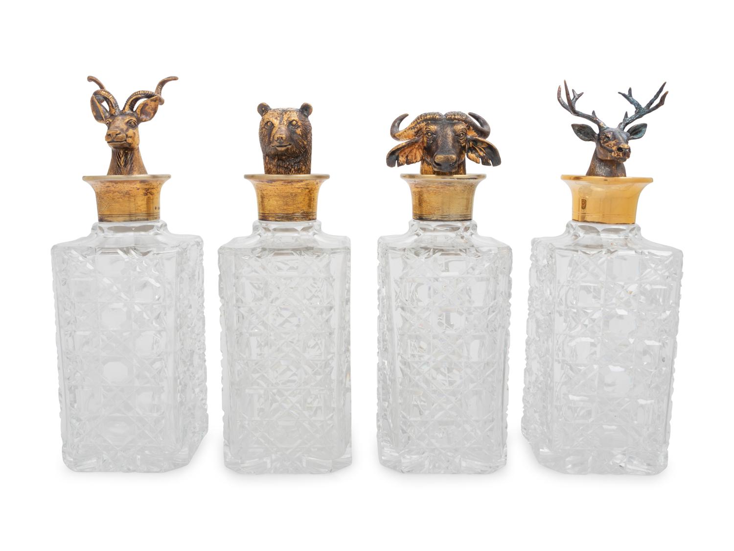 A Set of Four English Silver Mounted Cut-Glass Decanters