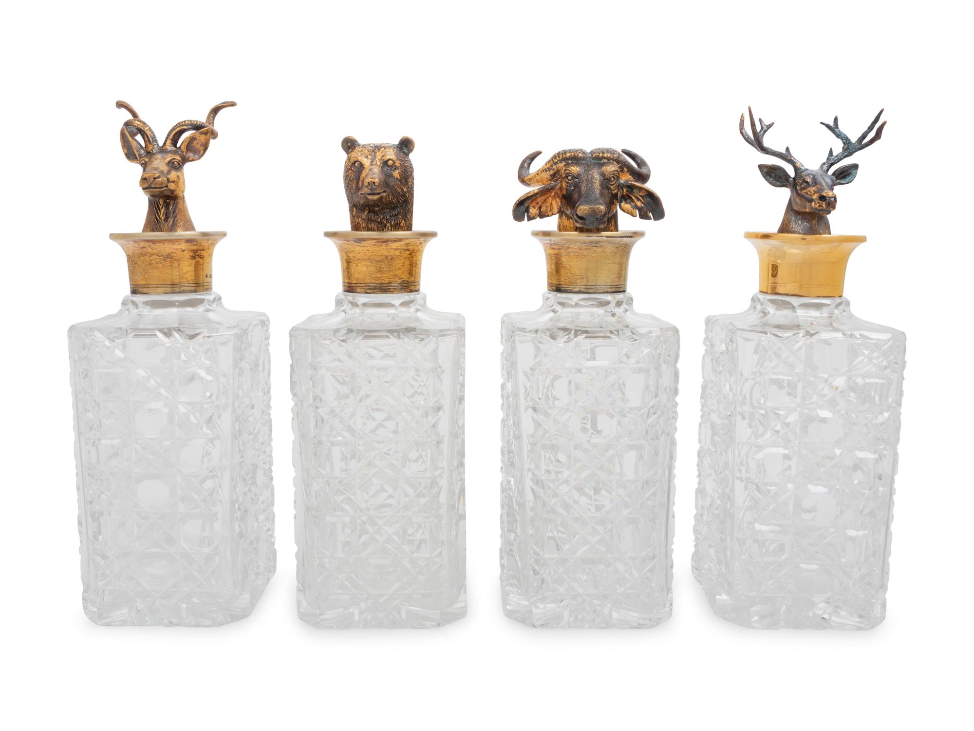 A Set of Four English Silver Mounted Cut-Glass Decanters