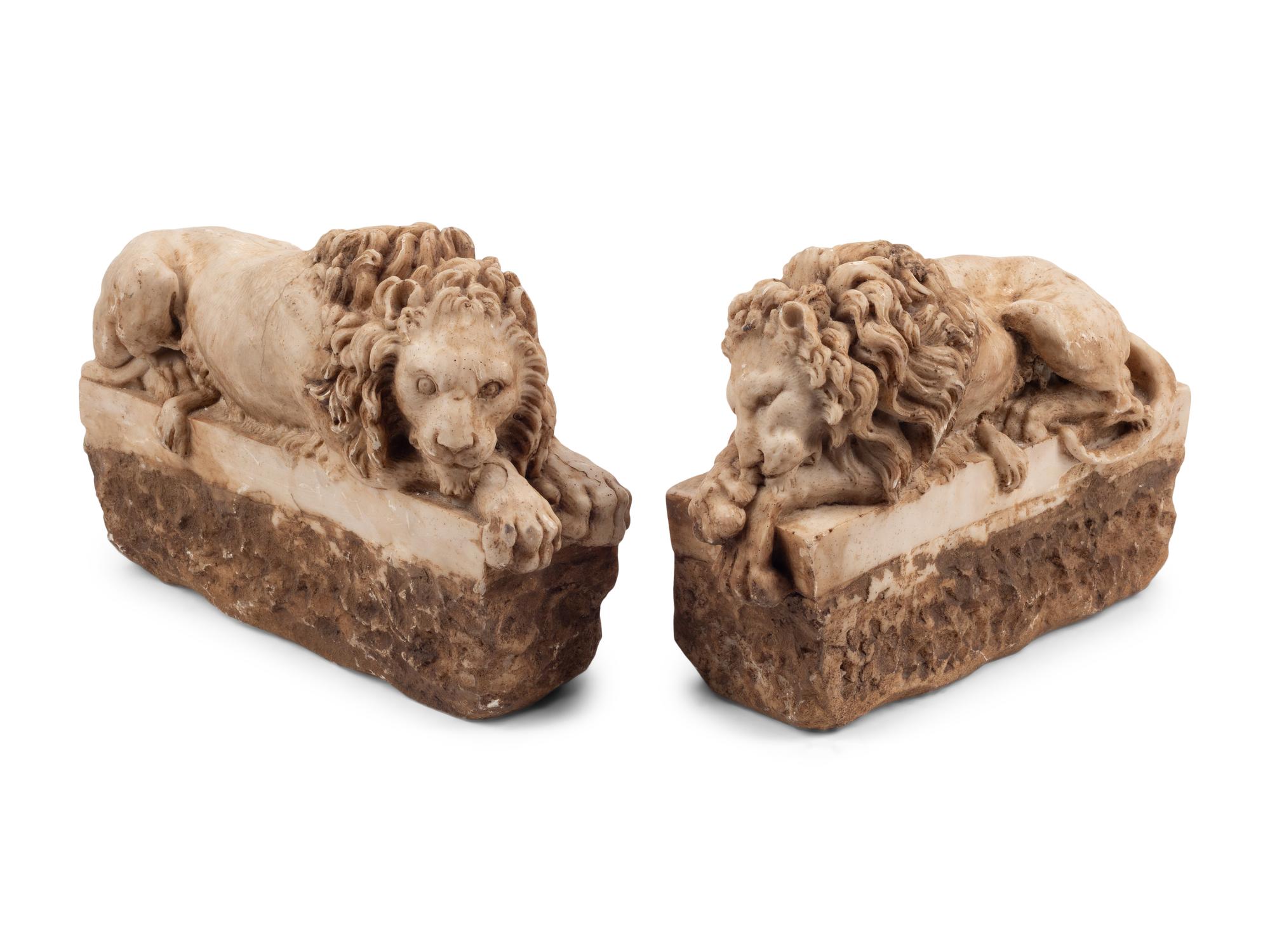 A Pair of Composition Marble Recumbent Lions