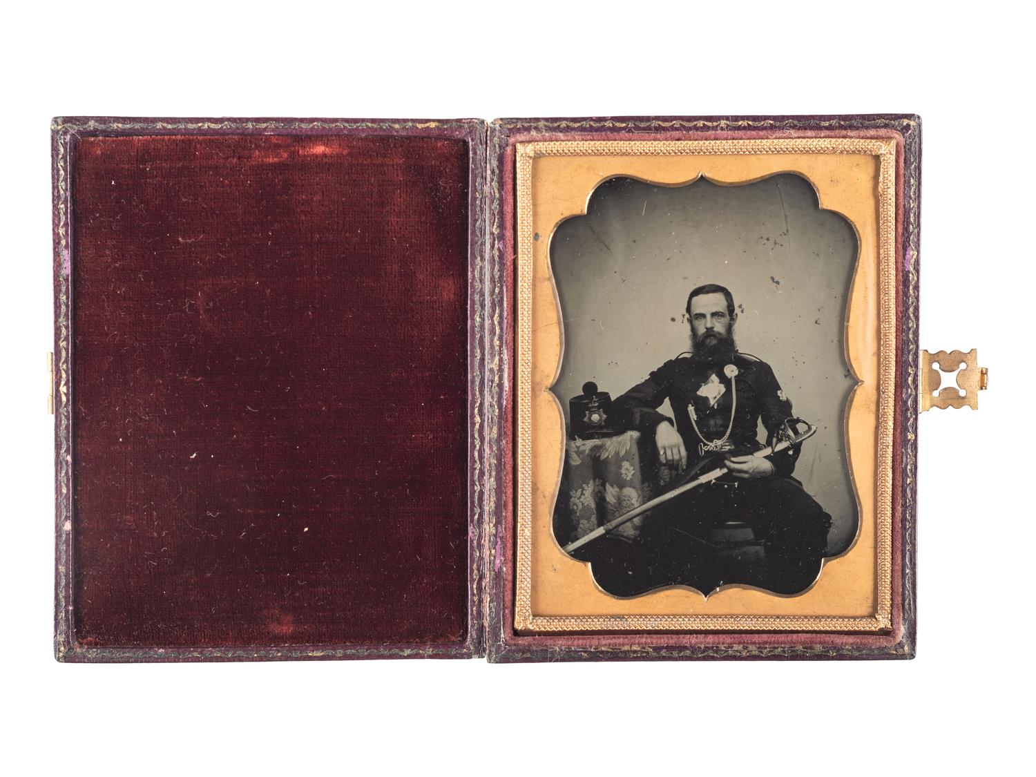 [EARLY PHOTOGRAPHY - MILITARY]. Quarter plate ambrotype portrait of a English Rifle Volunteer officer holding his sword. [Ca late 1850s].