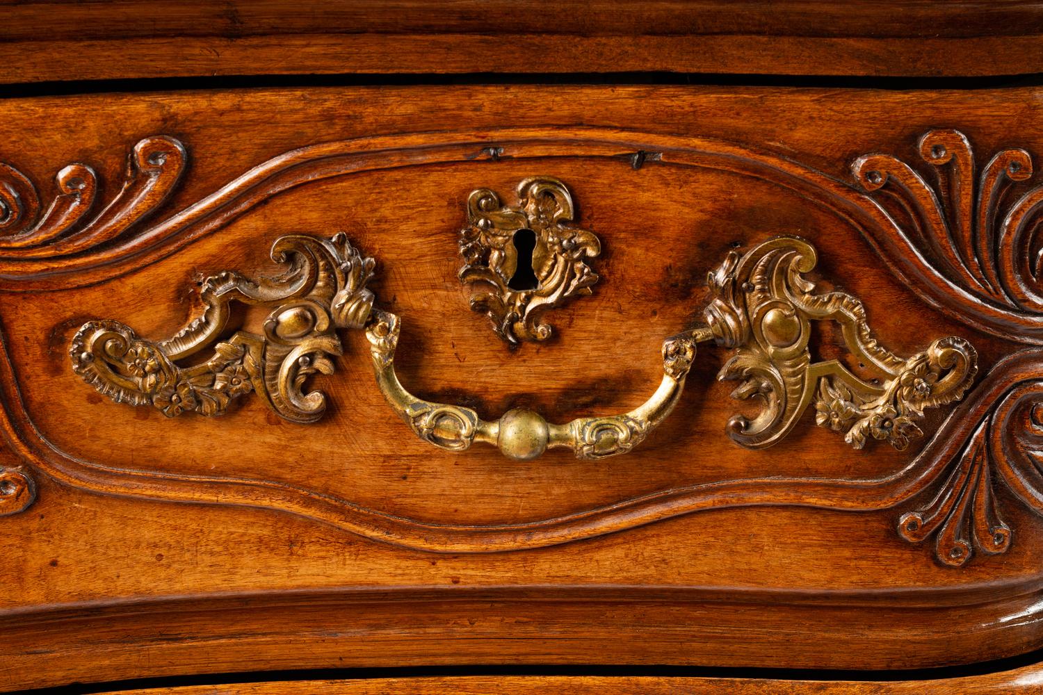 A Louis XV Provincial Carved Walnut Commode