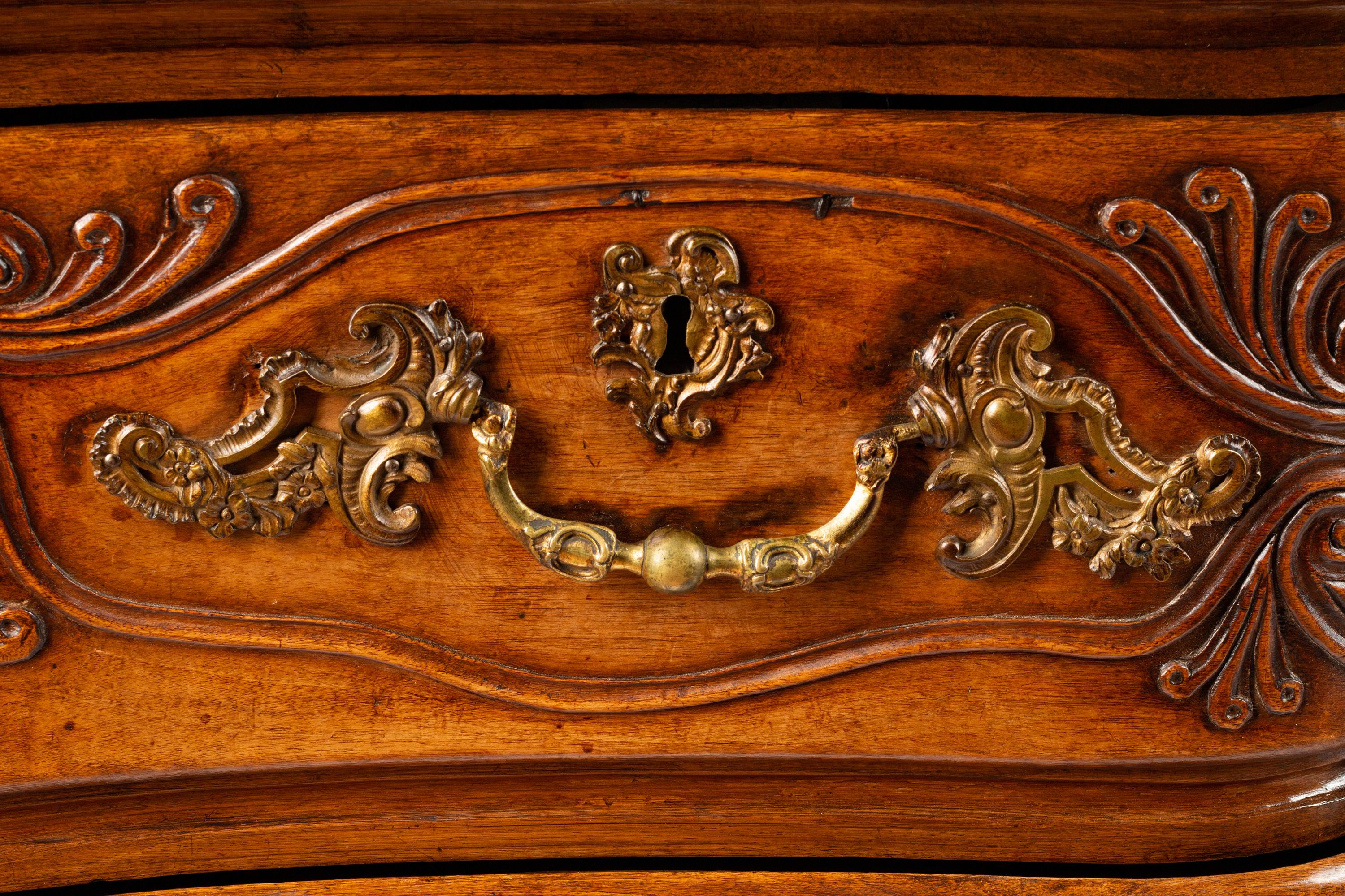 A Louis XV Provincial Carved Walnut Commode