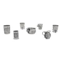 A Collection of Silver Repousse Decorated Table Articles