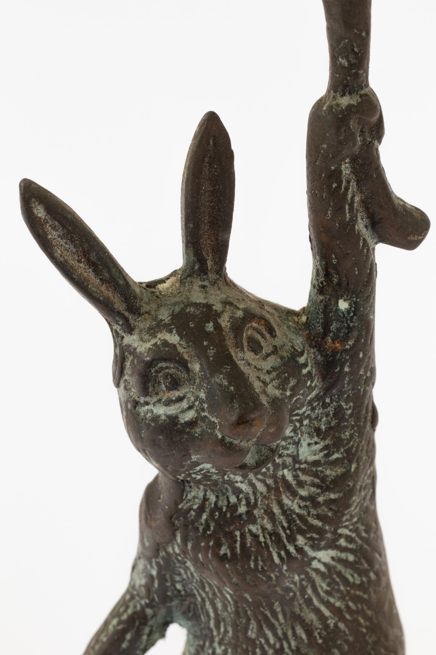 A Pair of Patinated Cast Metal Rabbit Candlesticks