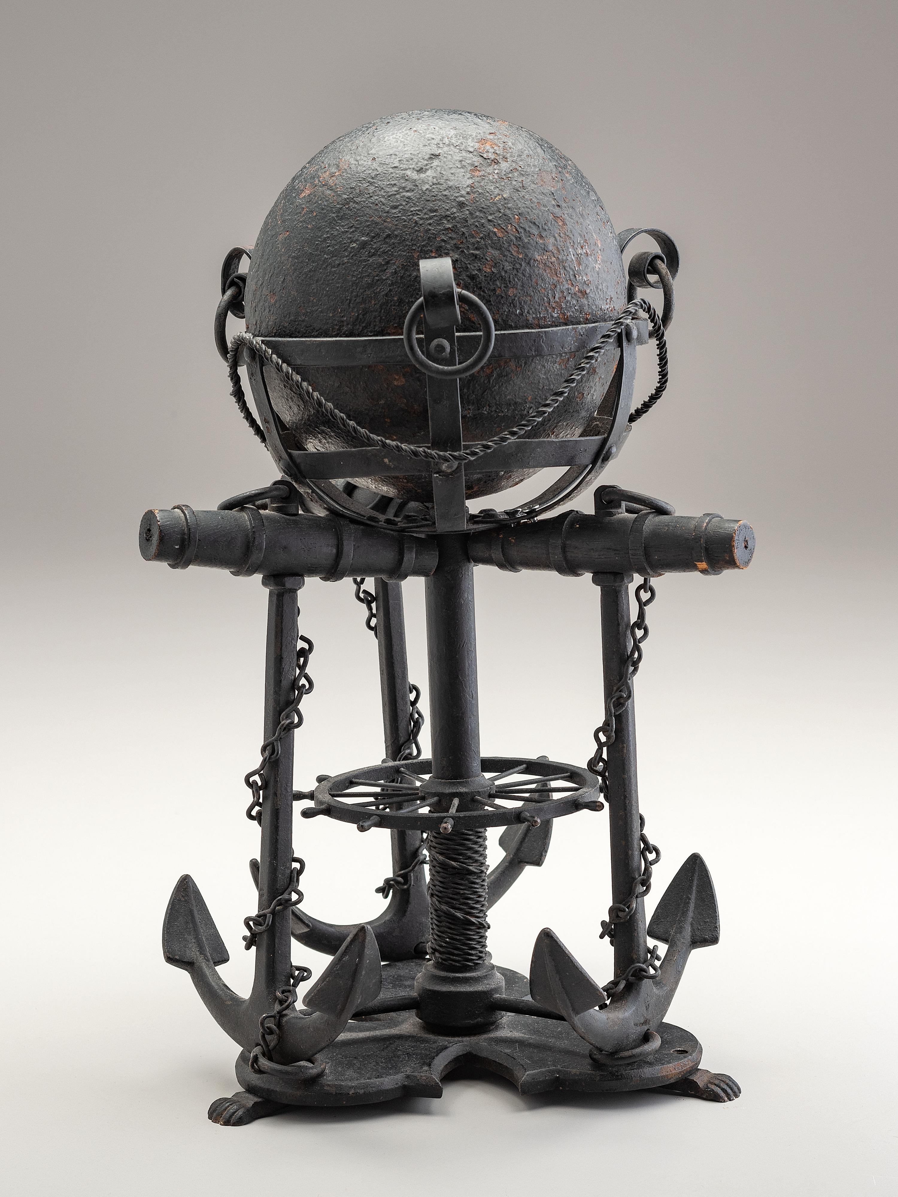 A Nautical Carved Wood and Iron Cannon Ball Stand