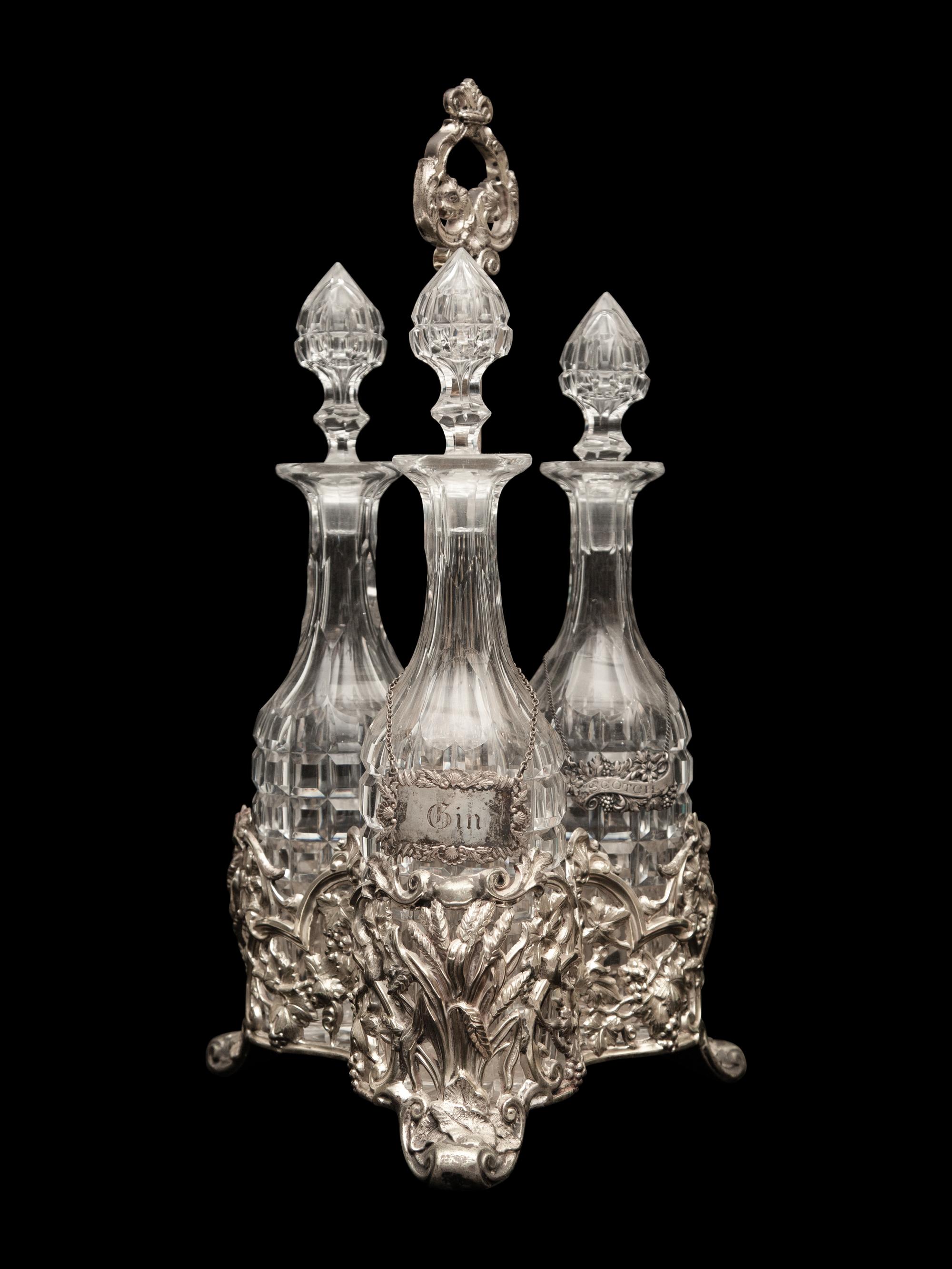 An English Silver-Plate Tantalus with Three Cut Glass Decanters