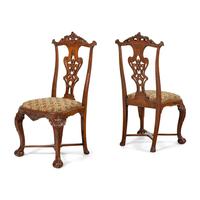 A Set of Four Portuguese Rococo Style Carved Walnut Dining Chairs