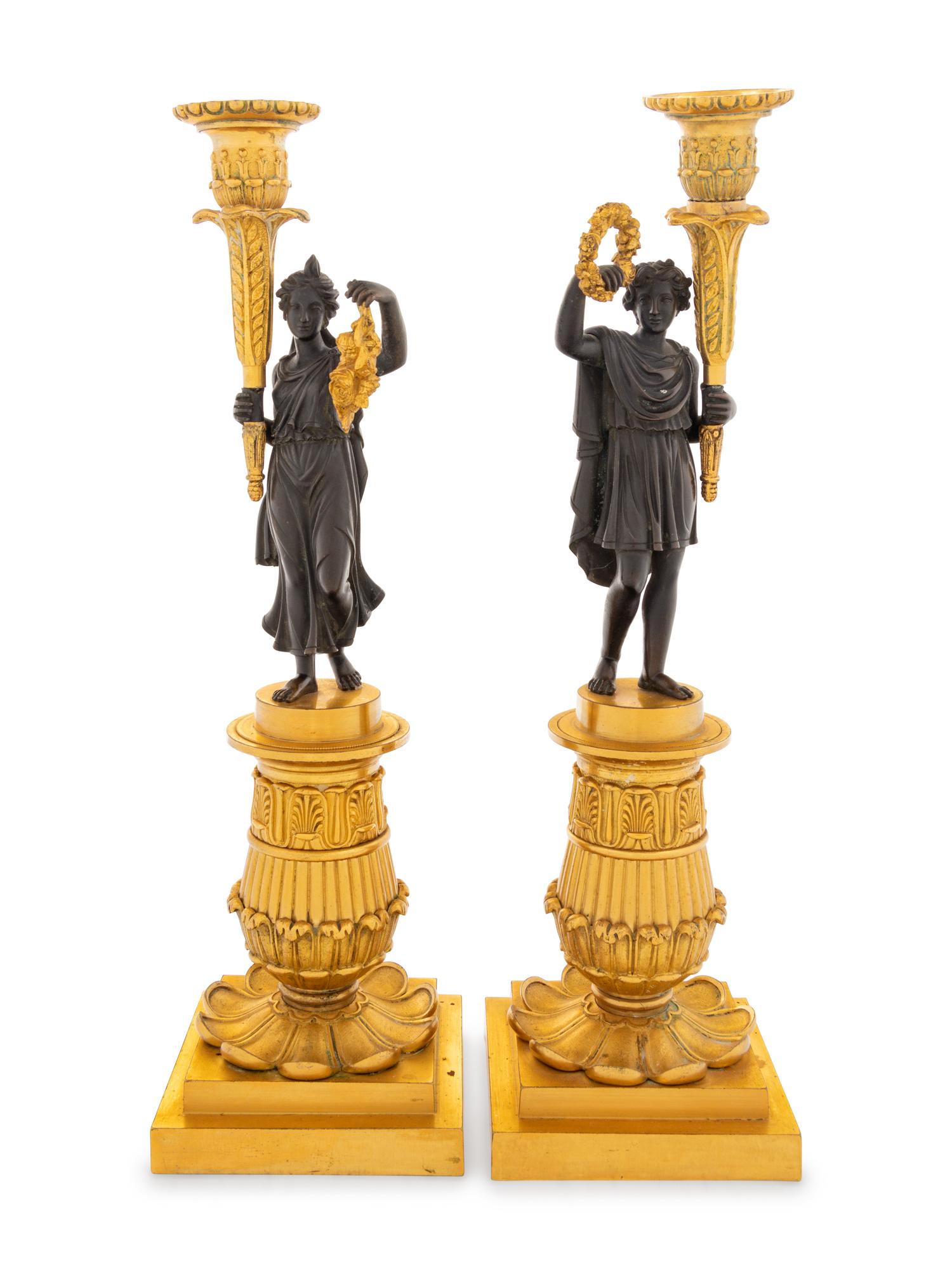 A Pair of Charles X Style Gilt and Patinated Bronze Figural Candlesticks