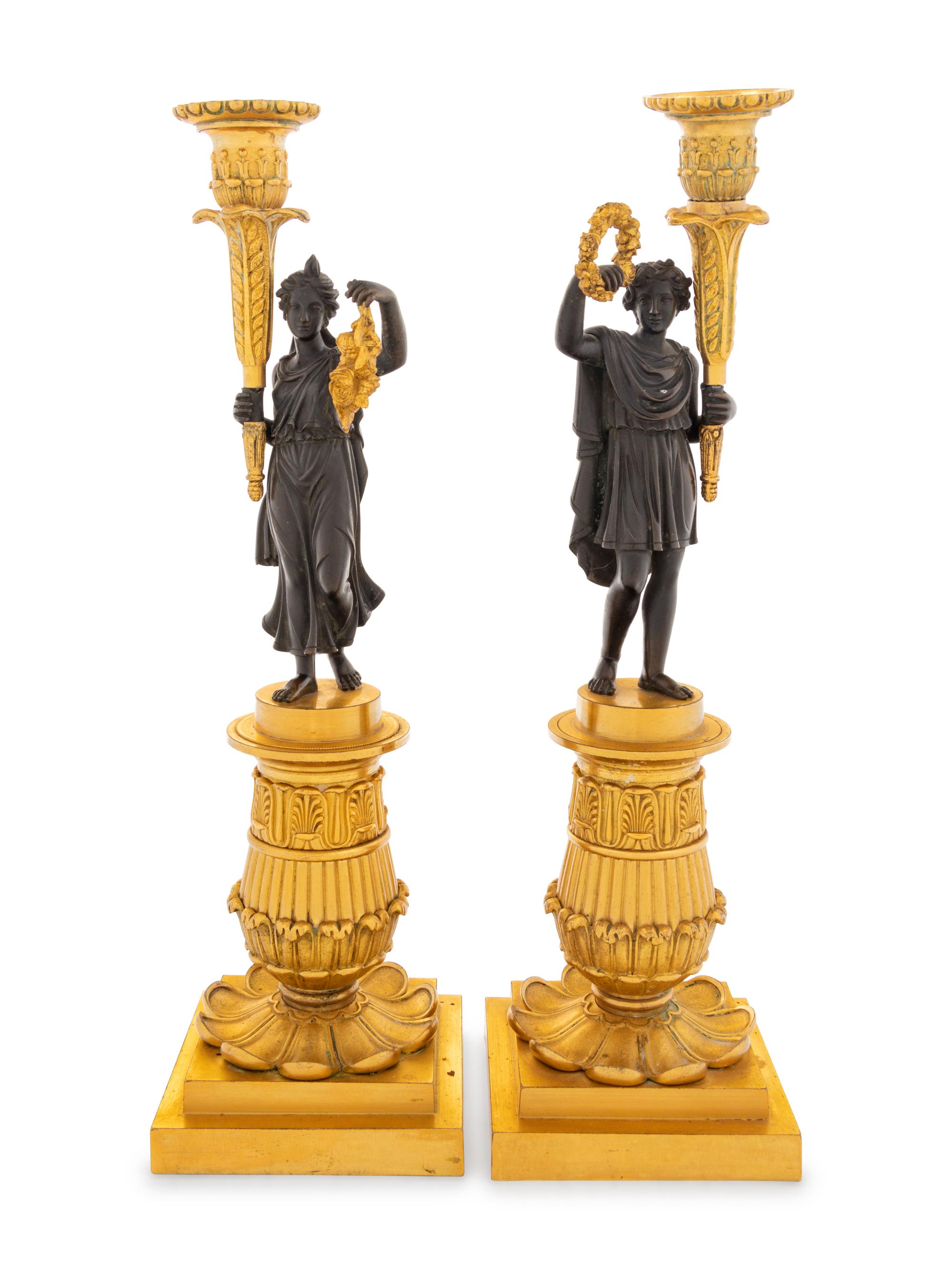 A Pair of Charles X Style Gilt and Patinated Bronze Figural Candlesticks