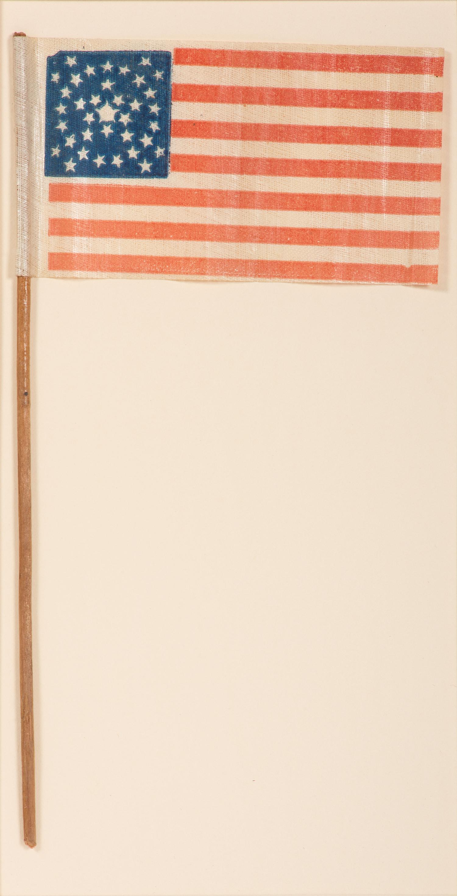 [FLAGS]. 36-star American parade flag in a rare "Great-Star-in-a-Wreath" pattern. Ca 1865-1867.