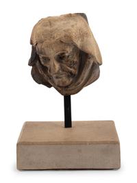 A Continental Carved Stone Head
