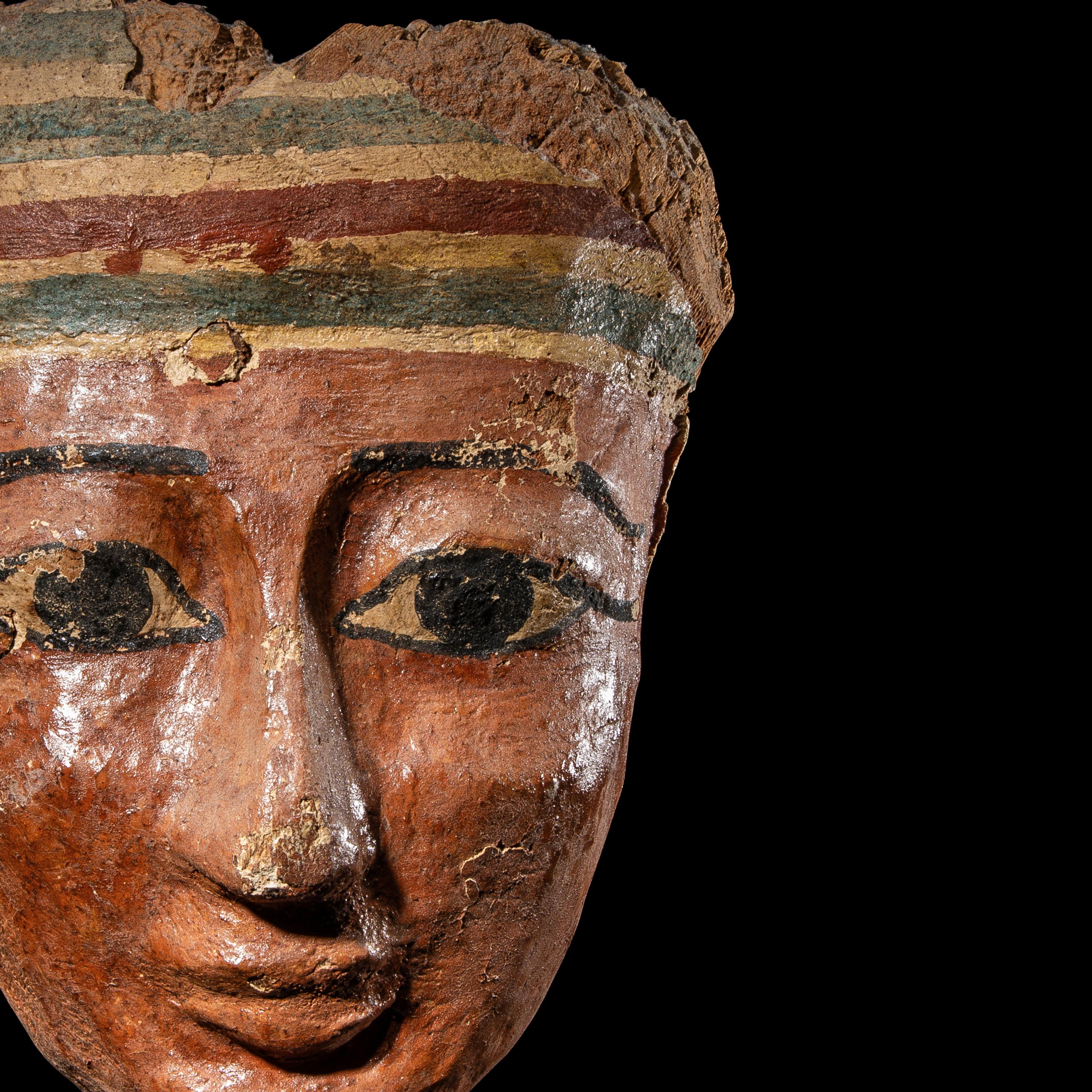 An Egyptian Painted Wood Mummy Mask