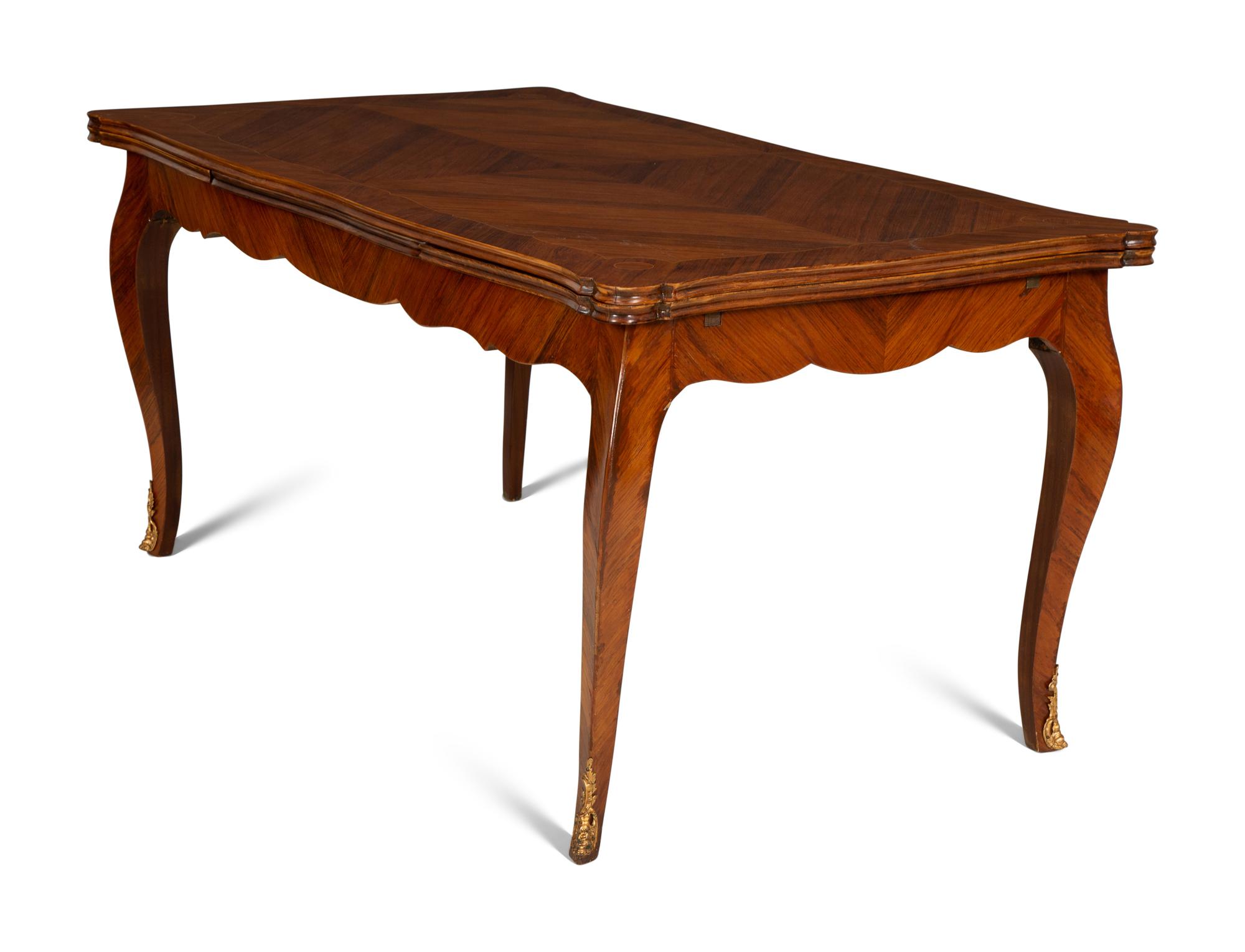A Louis XV Style Gilt Bronze Mounted Tulipwood and Marquetry Extension Dining Table