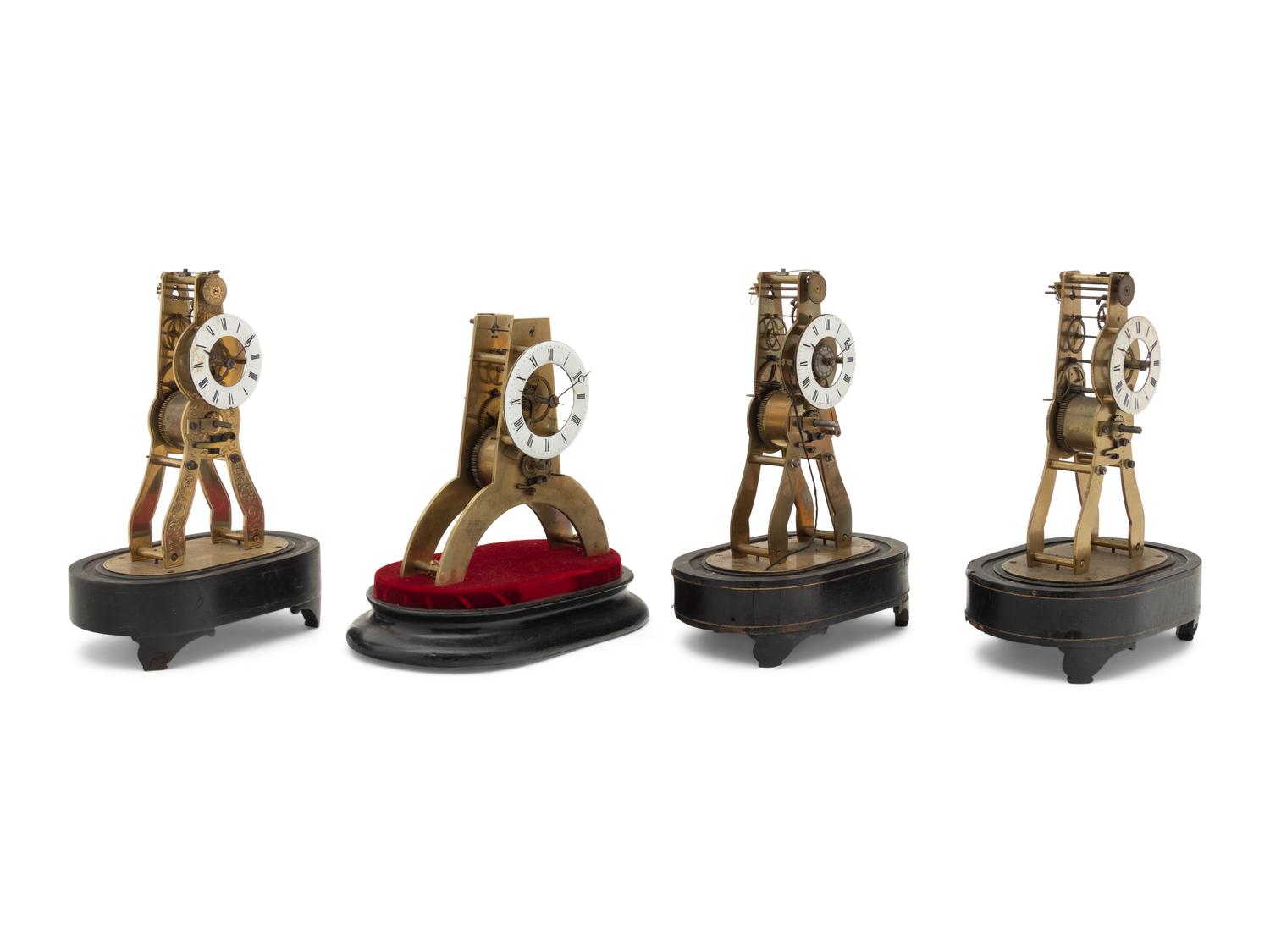 A Group of Four Brass Skeleton Clocks