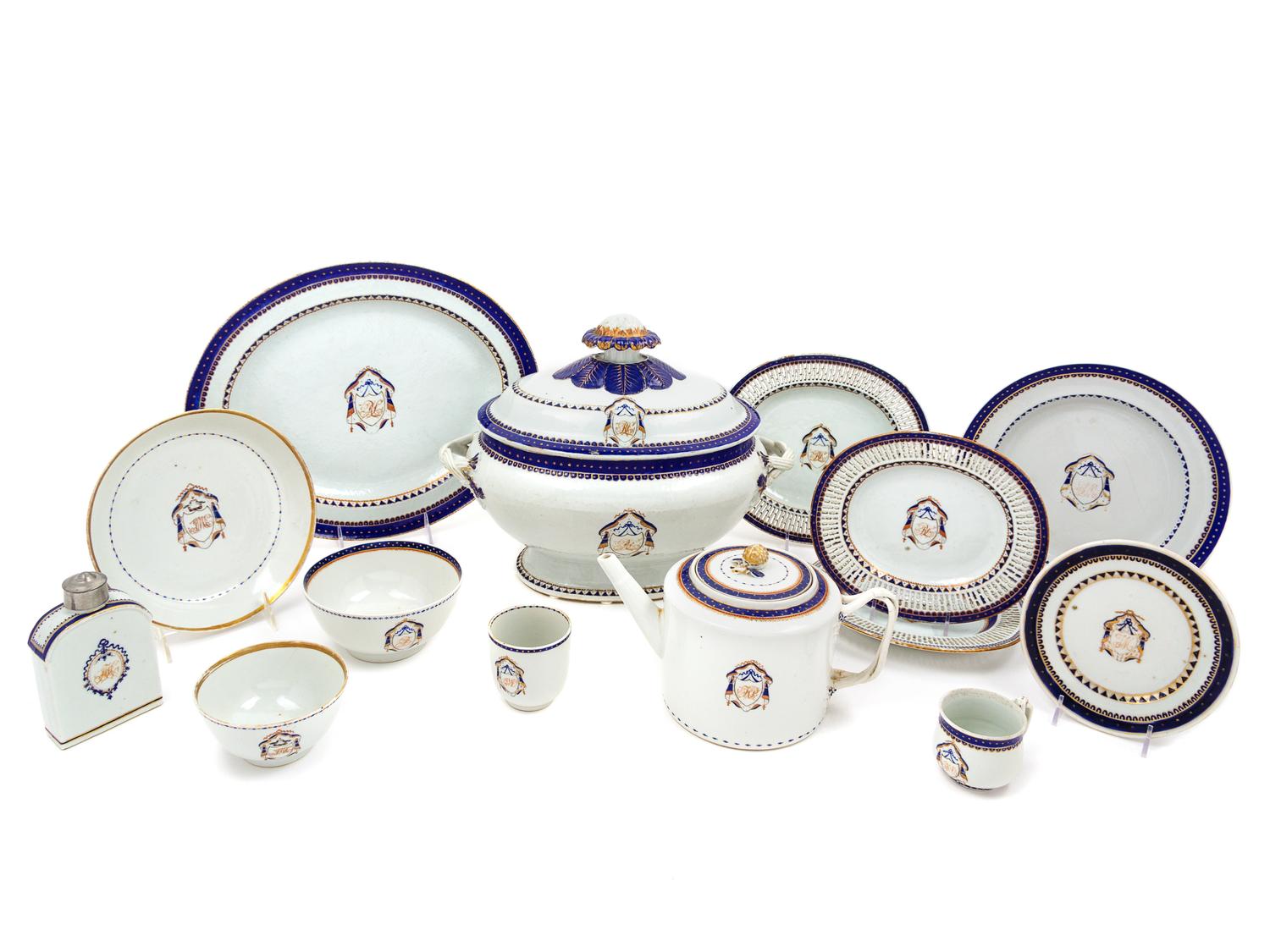 A Chinese Export Parcel Gilt, Blue and White Decorated Armorial Porcelain Partial Dinner Service