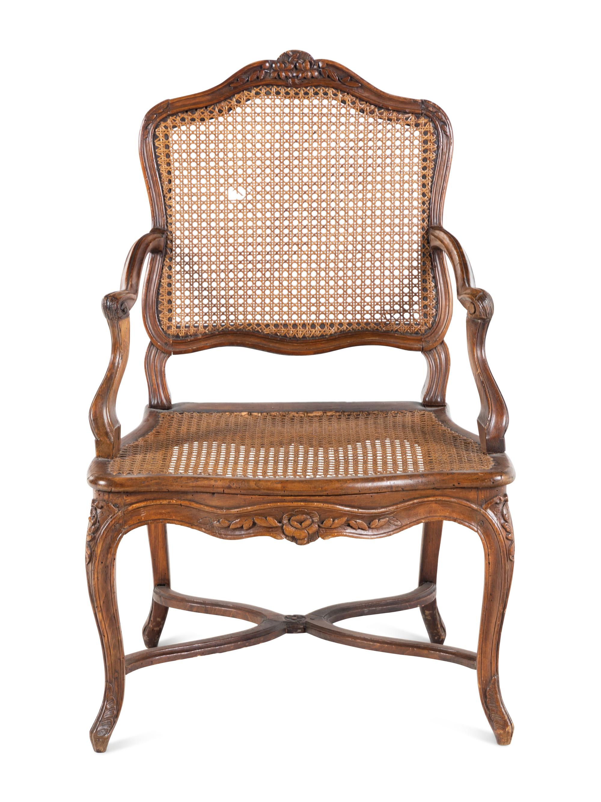 A Régence Carved Walnut and Caned Fauteuil
