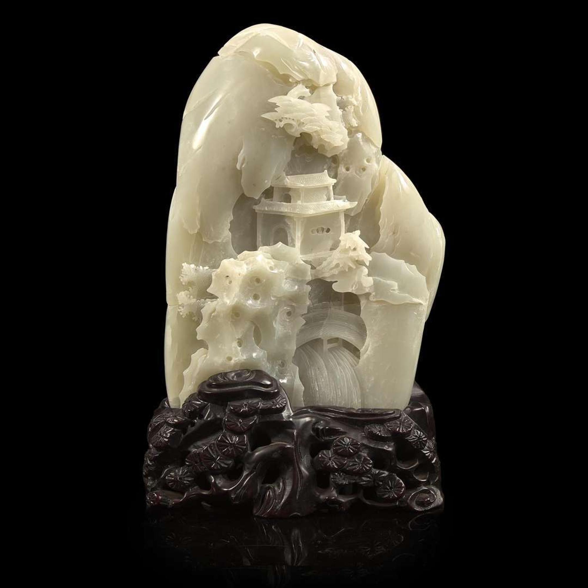 A Chinese carved greyish-white jade "Mountain" and carved wood stand 灰白玉山子及木底座 20th century ????