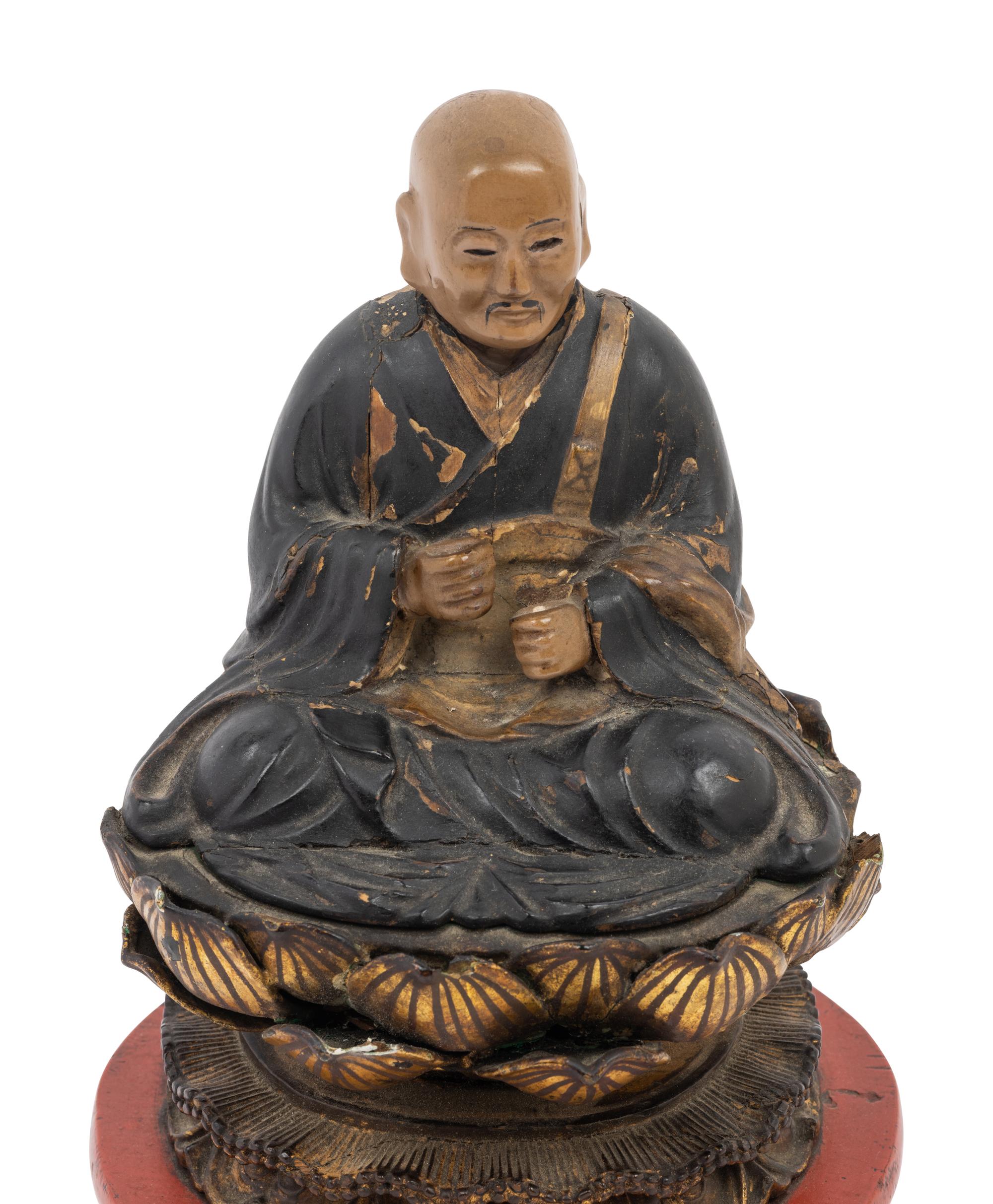 A Japanese Lacquered Wood Figure of a Seated Monk