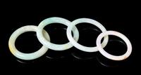 Four Jadeite Bangles Diameter overall of largest 2 7/8 inches.