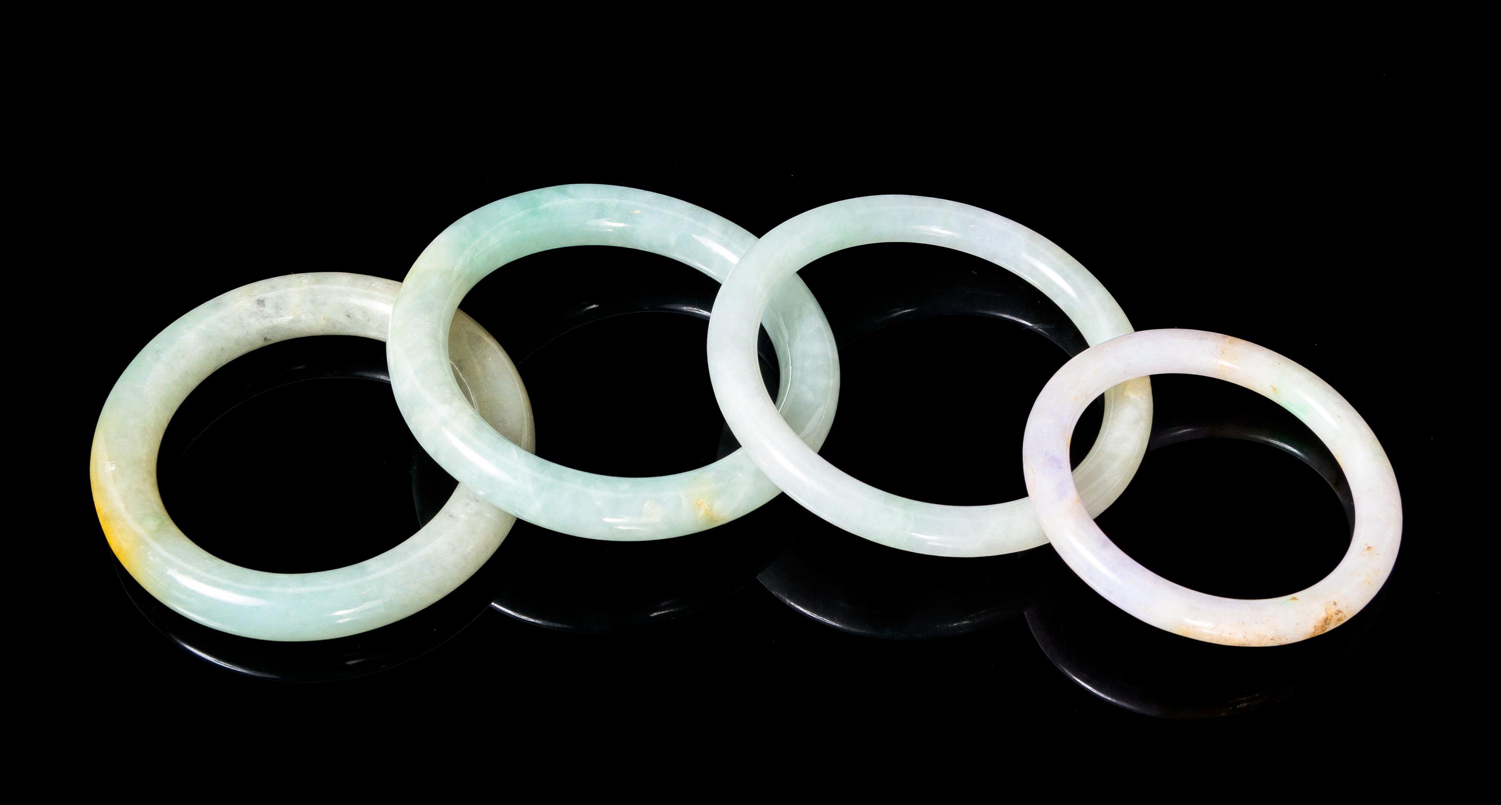 Four Jadeite Bangles Diameter overall of largest 2 7/8 inches.