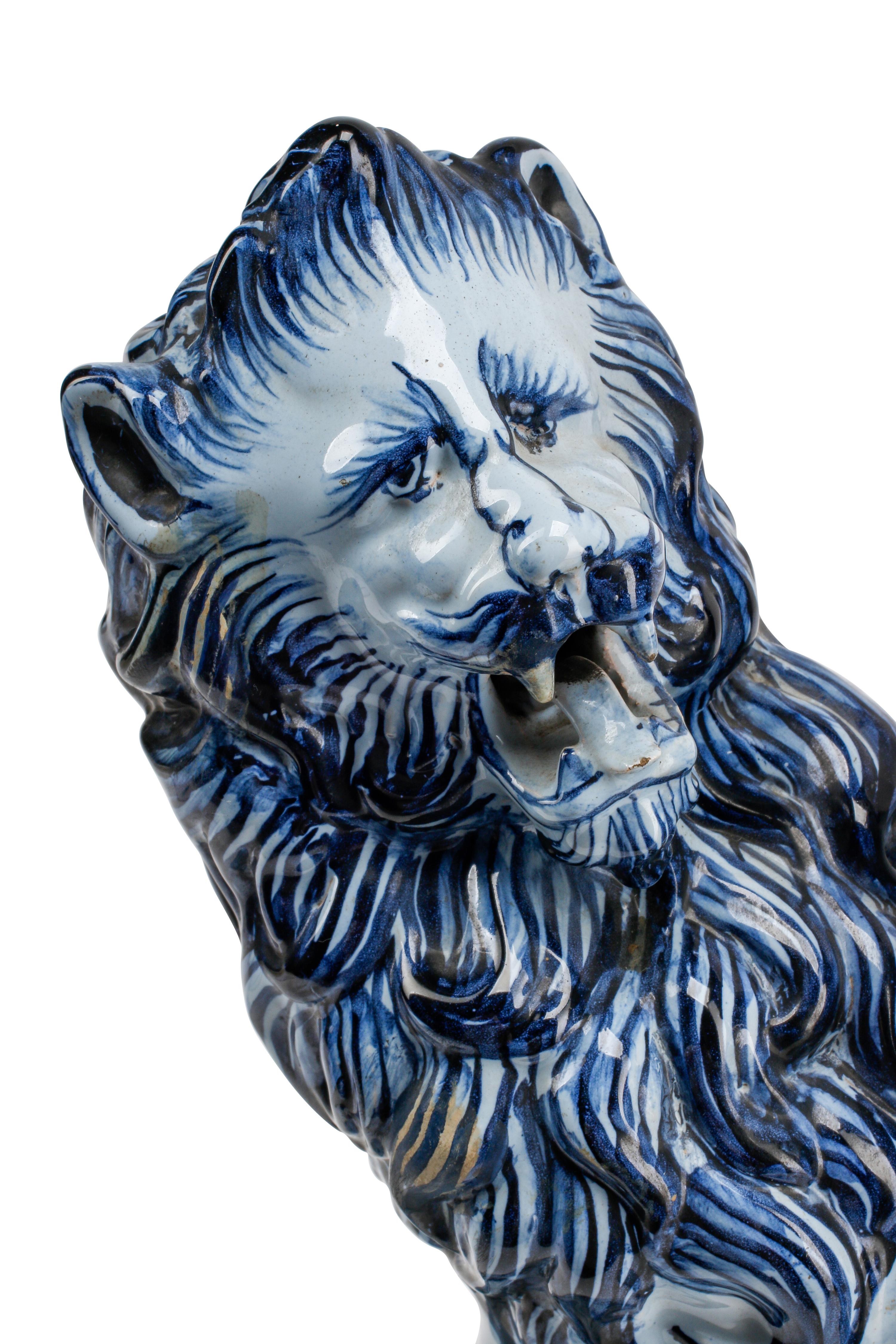 A Pair of French Faience Lion-Form Candlesticks