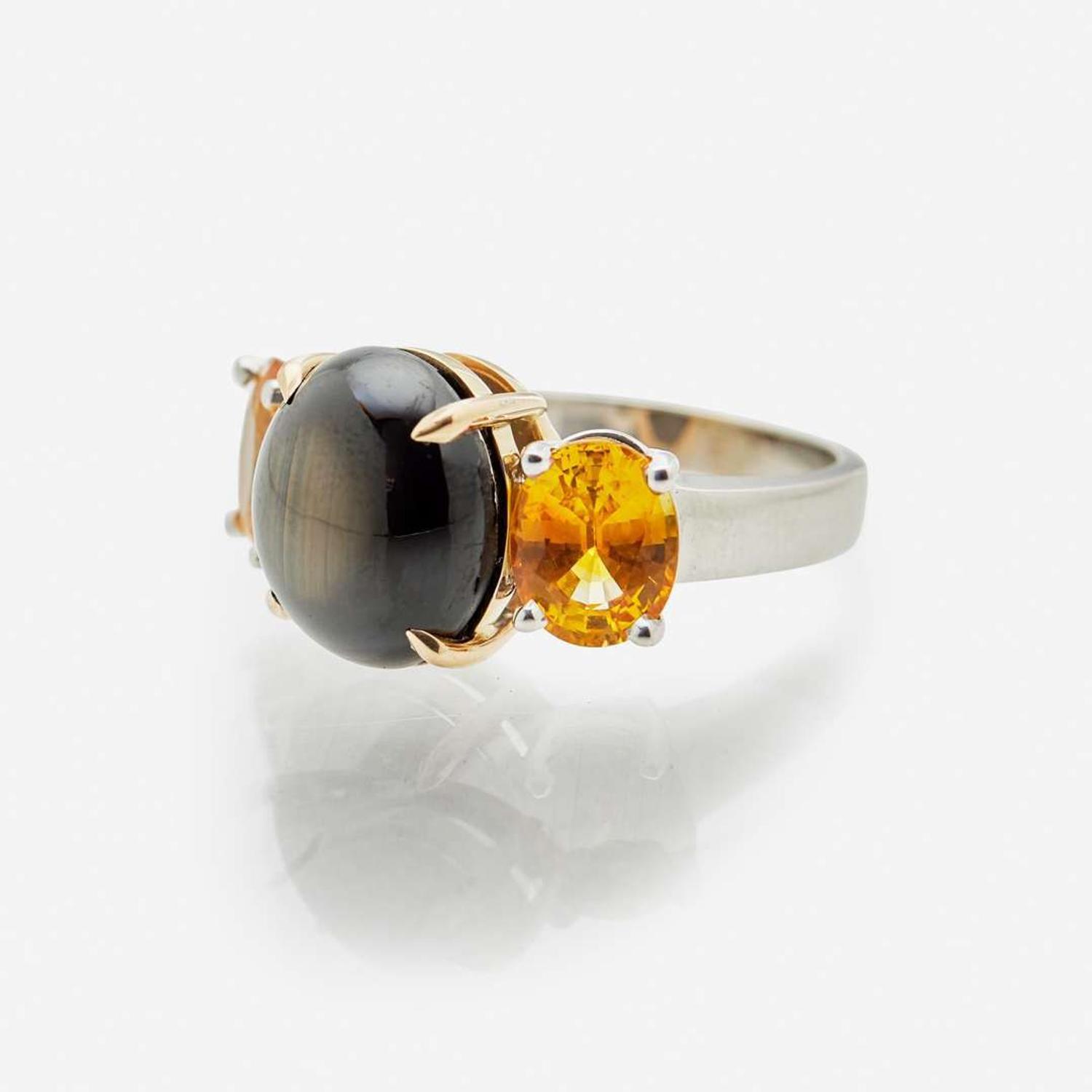 A Black Star Sapphire and Yellow Sapphire Ring