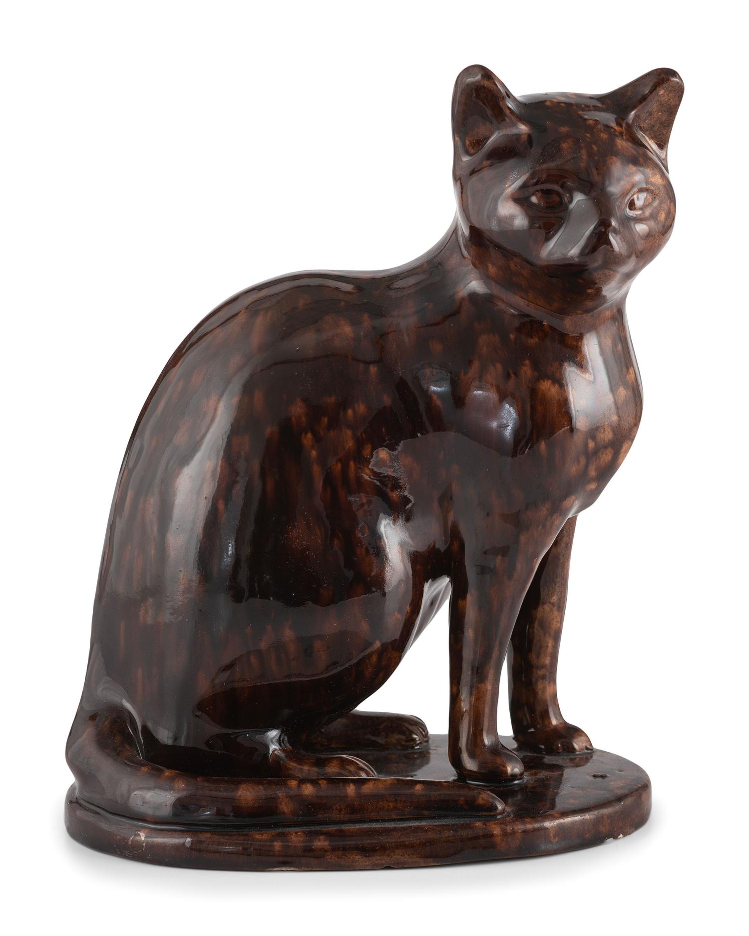 A Seated Cat Figure In Rockingham Glaze