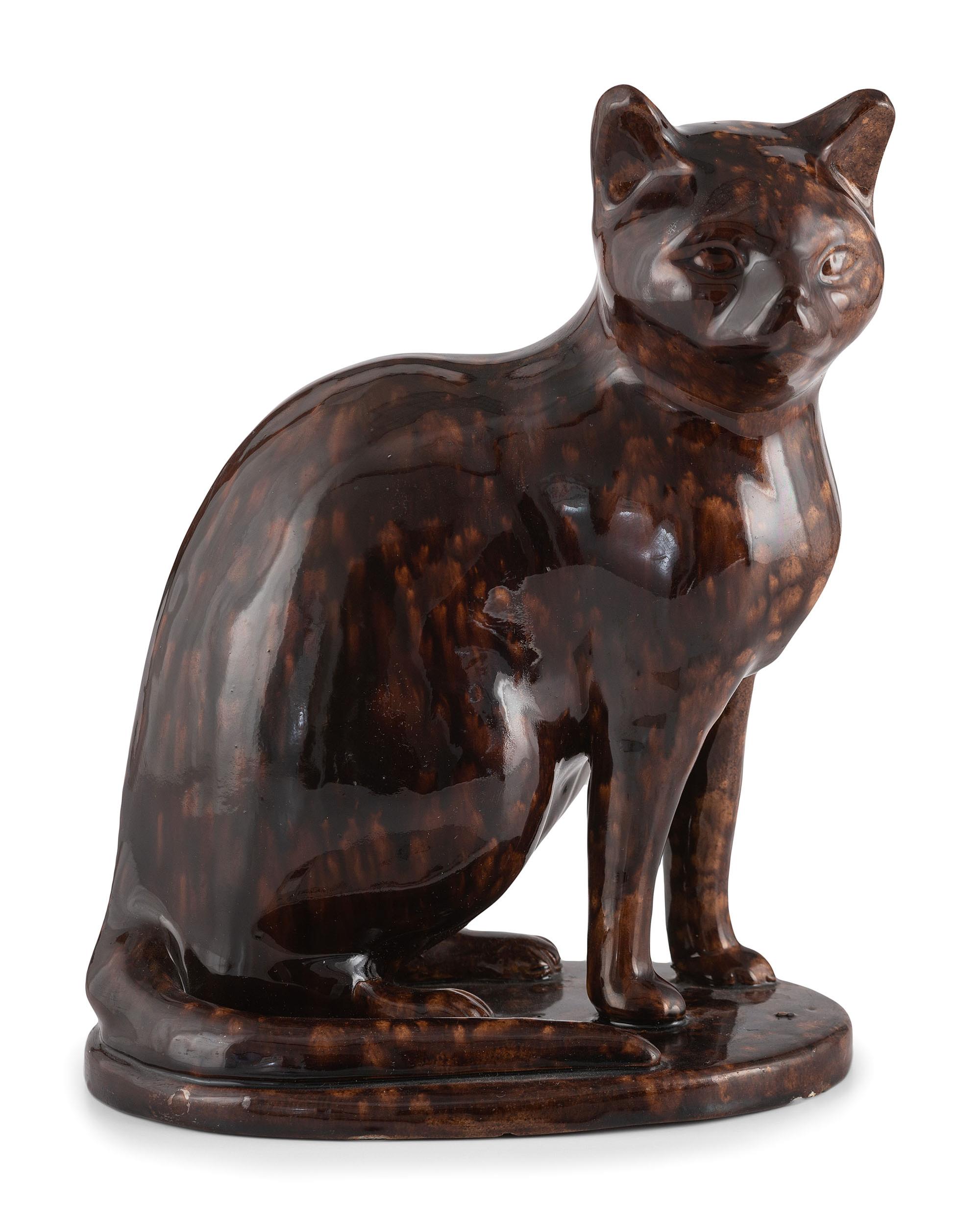 A Seated Cat Figure In Rockingham Glaze
