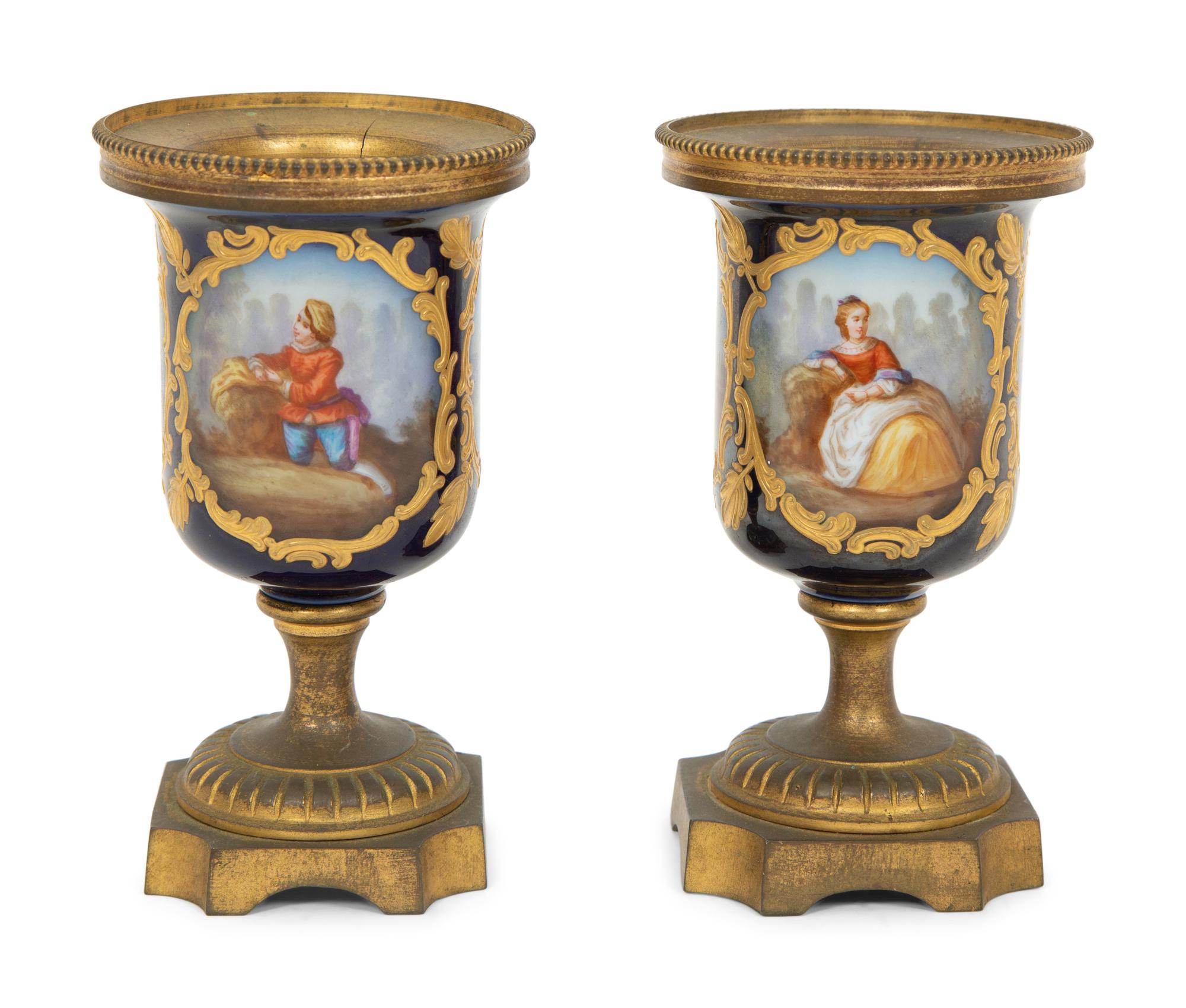 A Pair of Small Sevrés Style Porcelain and Gilt Bronze Urns