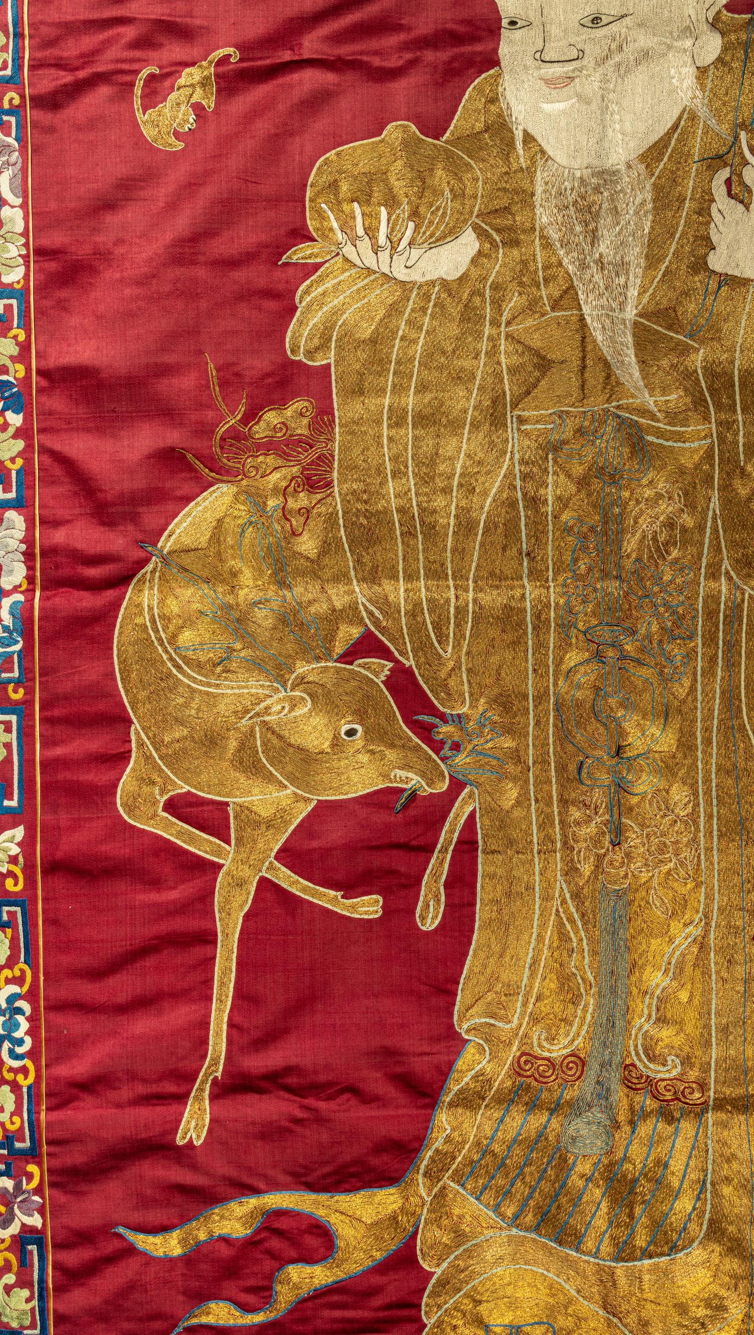 A Large Chinese Red Ground Embroidered Silk 'Longevity' Panel
