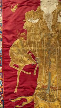 A Large Chinese Red Ground Embroidered Silk 'Longevity' Panel