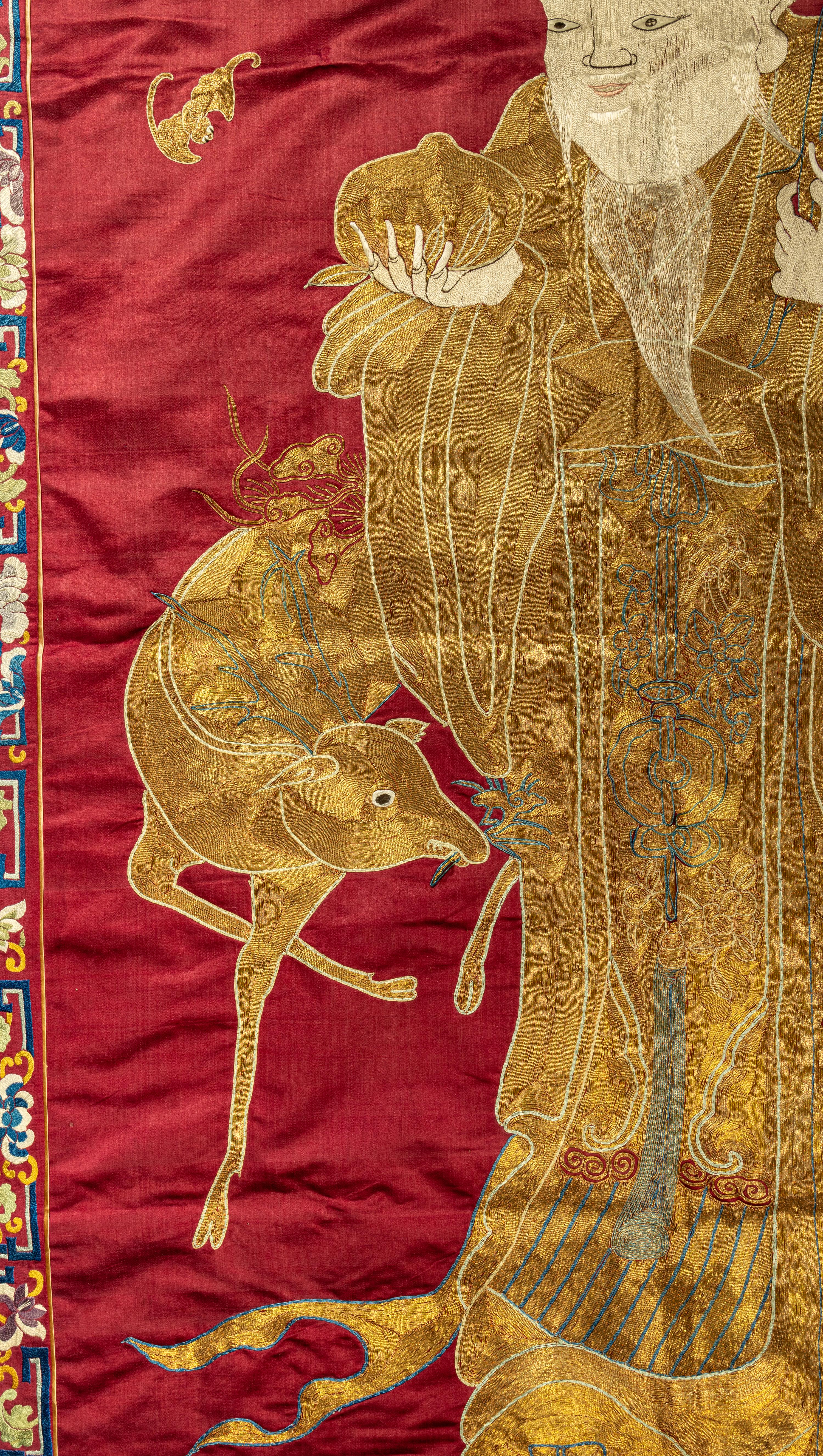 A Large Chinese Red Ground Embroidered Silk 'Longevity' Panel