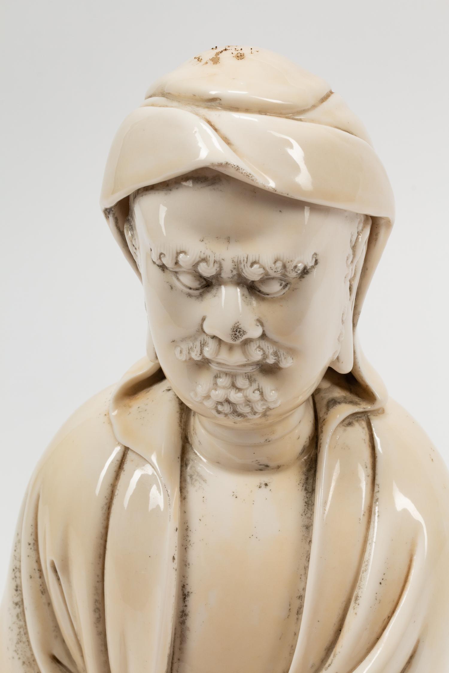 A Chinese Export White Glazed Porcelain Figure of a Seated Luohan