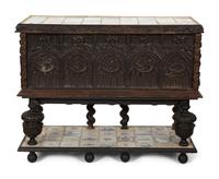 A Gothic Revival Carved Oak Tile-Mounted Chest on Stand