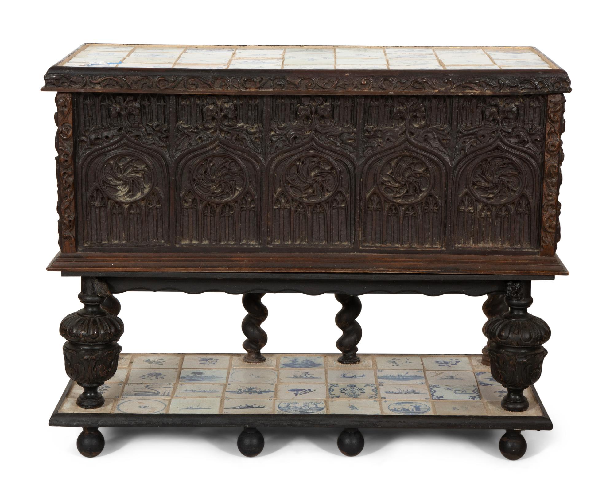 A Gothic Revival Carved Oak Tile-Mounted Chest on Stand