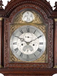 An English Tall Case Clock with Finely Carved Oak Case