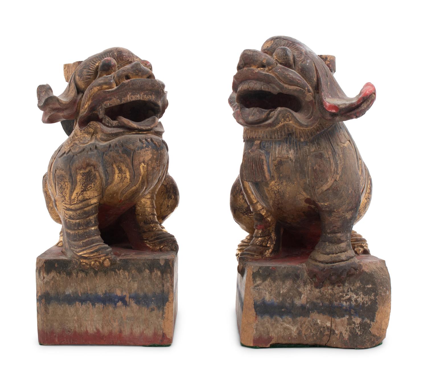 A Pair of Chinese Giltwood Candlesticks with Buddhistic Lions