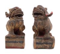 A Pair of Chinese Giltwood Candlesticks with Buddhistic Lions