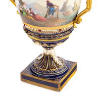 A Pair of Sèvres Style Gilt Bronze Mounted Porcelain Urns