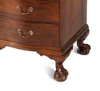 A Chippendale Mahogany and Cherrywood Serpentine Claw-and-Ball Foot Desk-and-Bookcase