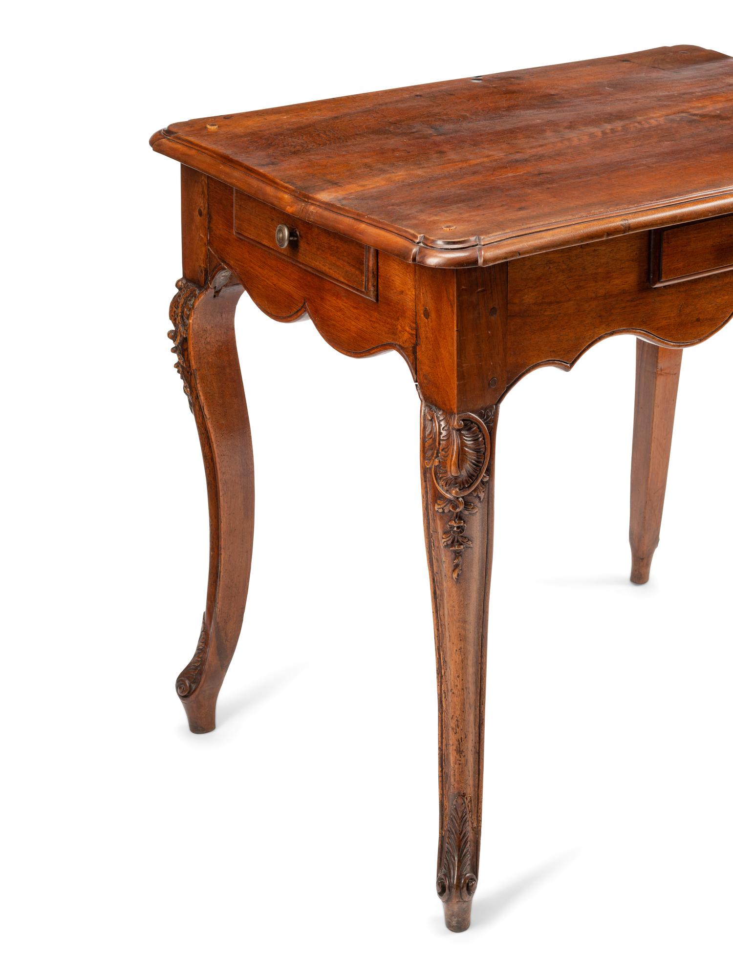 A Louis XV Walnut Four-Drawer Table