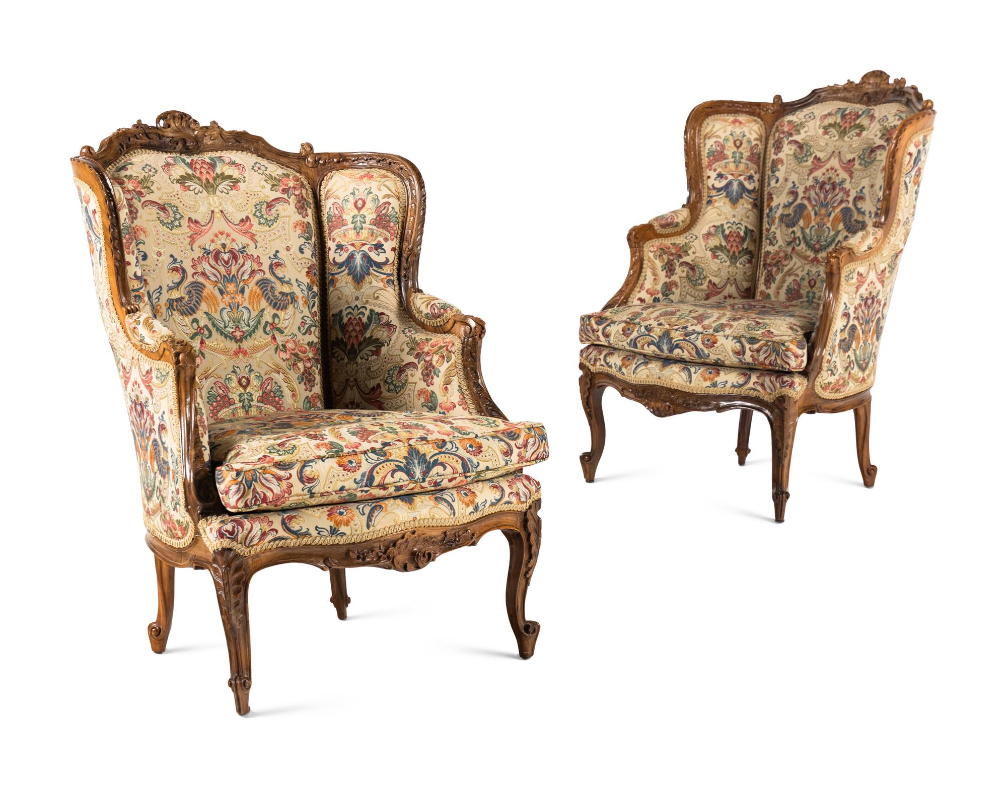 A Pair of Louis XV Style Carved Walnut Bergères