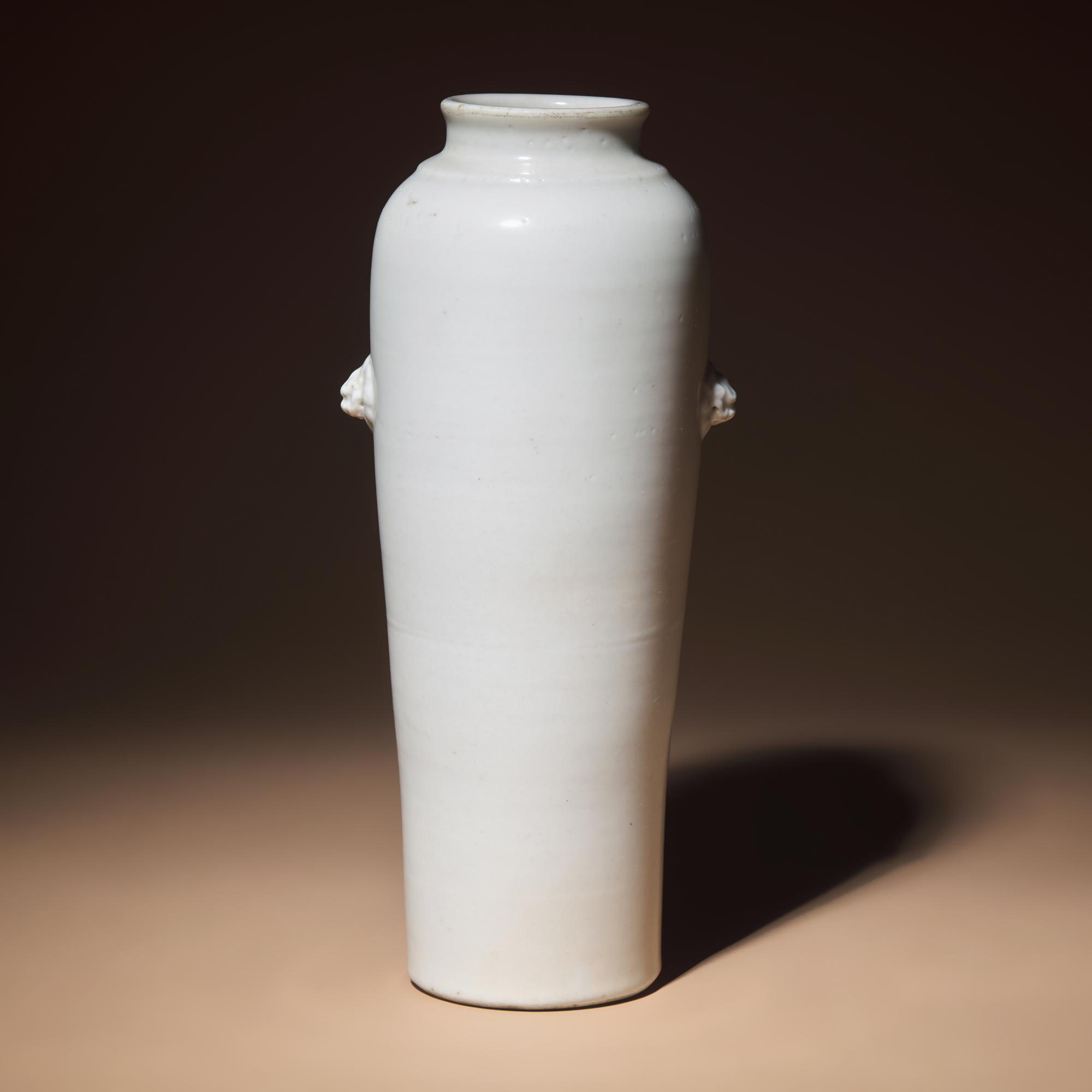 A Chinese Blanc-de-Chine Porcelain Sleeve Vase, Early Qing Dynasty — 清早期 德化白瓷雙獸首筒瓶
